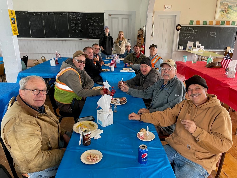  Volunteer lunch at the Como Civic Center, l to r around table, Bob Schoppe, Bob Revis, Pat Mauro, Alex Hois, server Alexia, our “outstanding cook” Leslie Cole, Jeannie Lawson, Nick Holt, Jim Scoville, Chris Tome, Joey Knous and David Kings 