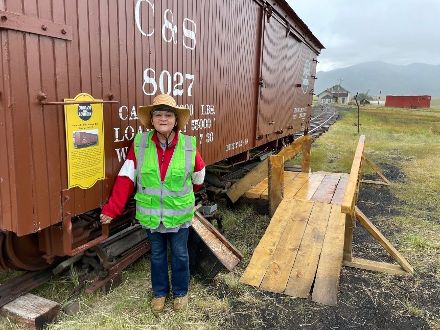Catherine Woodham, admiring the new C&amp;S #8027 history plaque, was busy organizing the “Archival Boxcar”