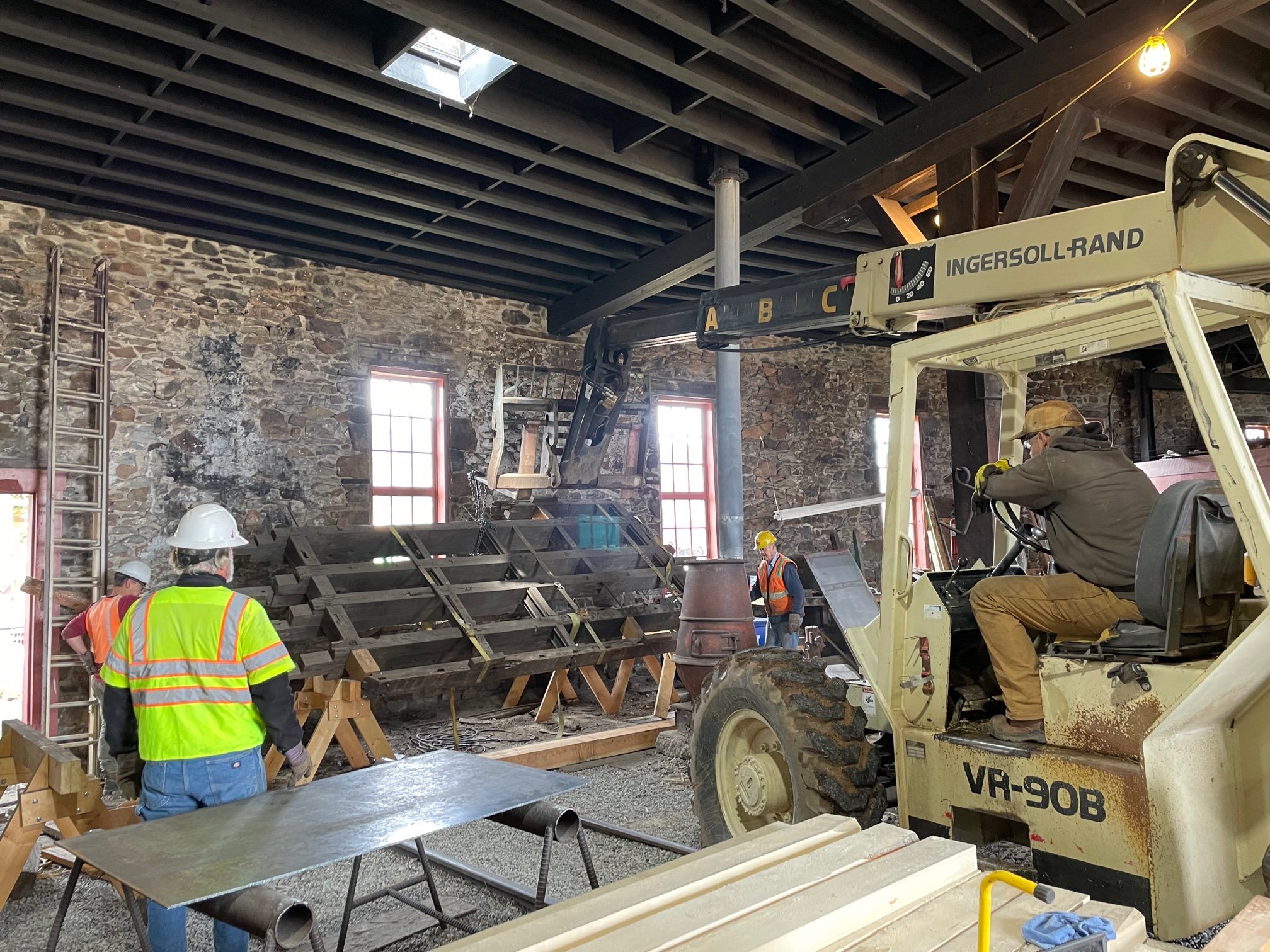 Road Master Alex Hois, James Makay, Jim McBee, Jim Scoville and Bob Revis relocating cabose frame to provide location of water tank staves to ready for additional milling