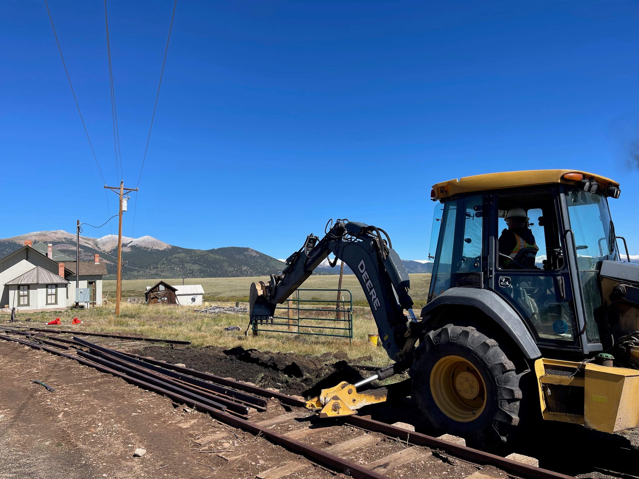  South Park Rail Society Vice President and Operations Manager Bob Revis diligently operates the backhoe for the track crew.  