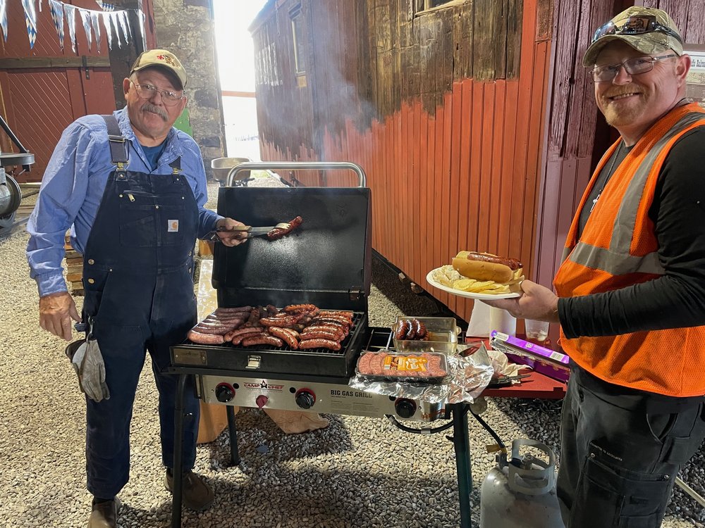  After work was completed Joey Knous fired up the grill cooking Brats with John Kaszanek about to enjoy and the Volunteer Appreciation / Oktoberfest party commenced around the warm potbelly stove. 
