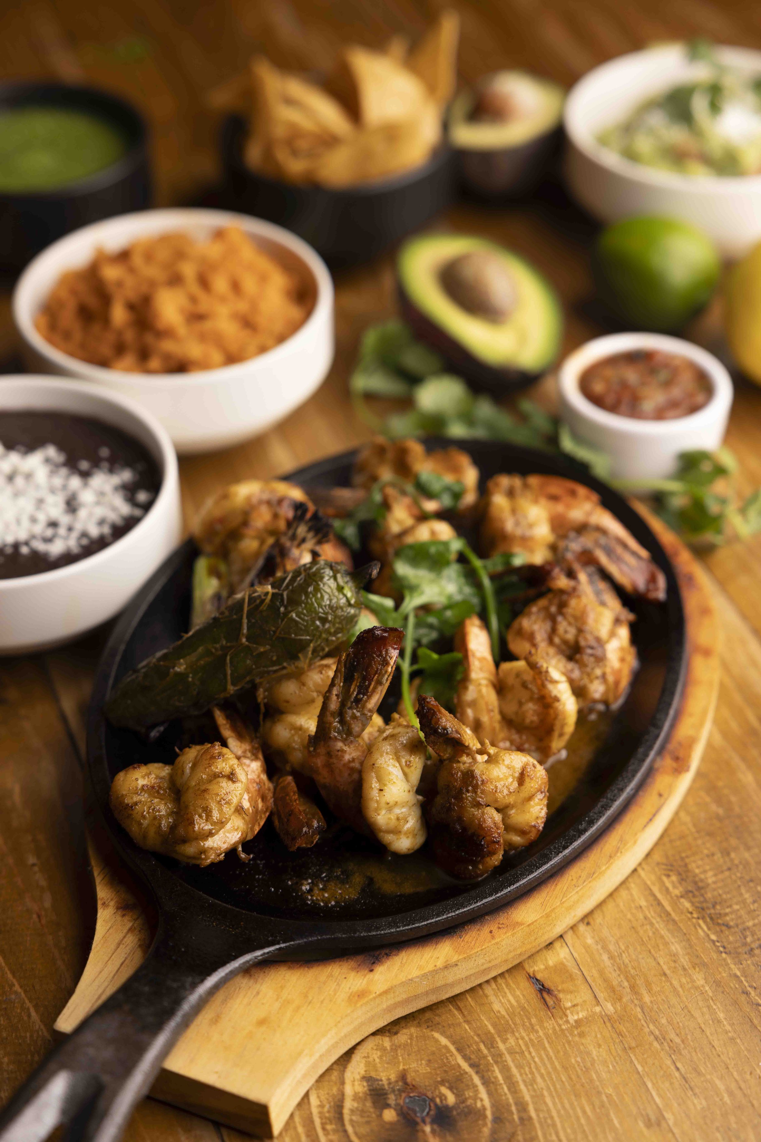 Photo by Chris Thurman, our shrimp fajitas sizzling and paired with rice, salsa and chips