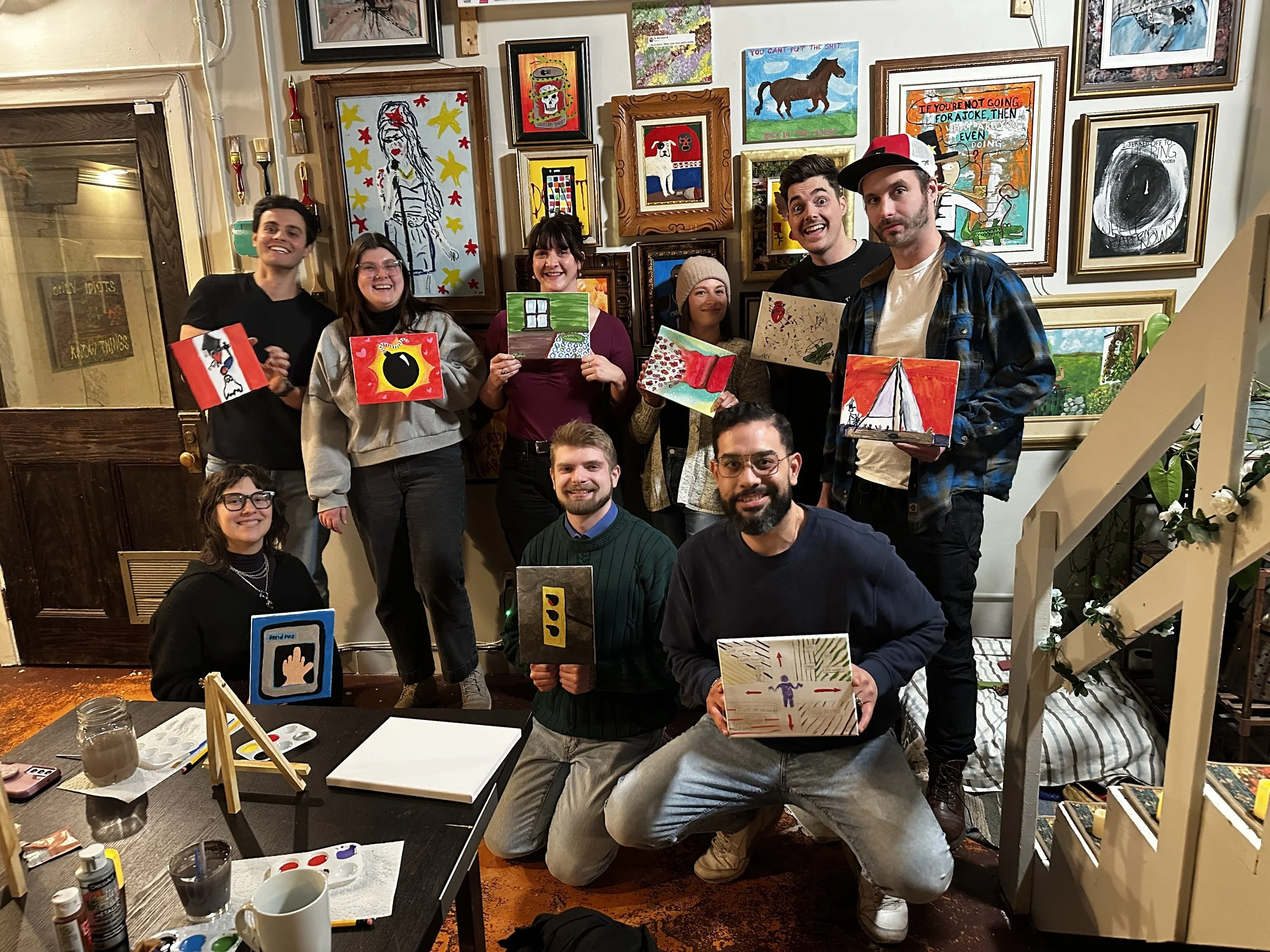 A group proudly shows off their finished artworks