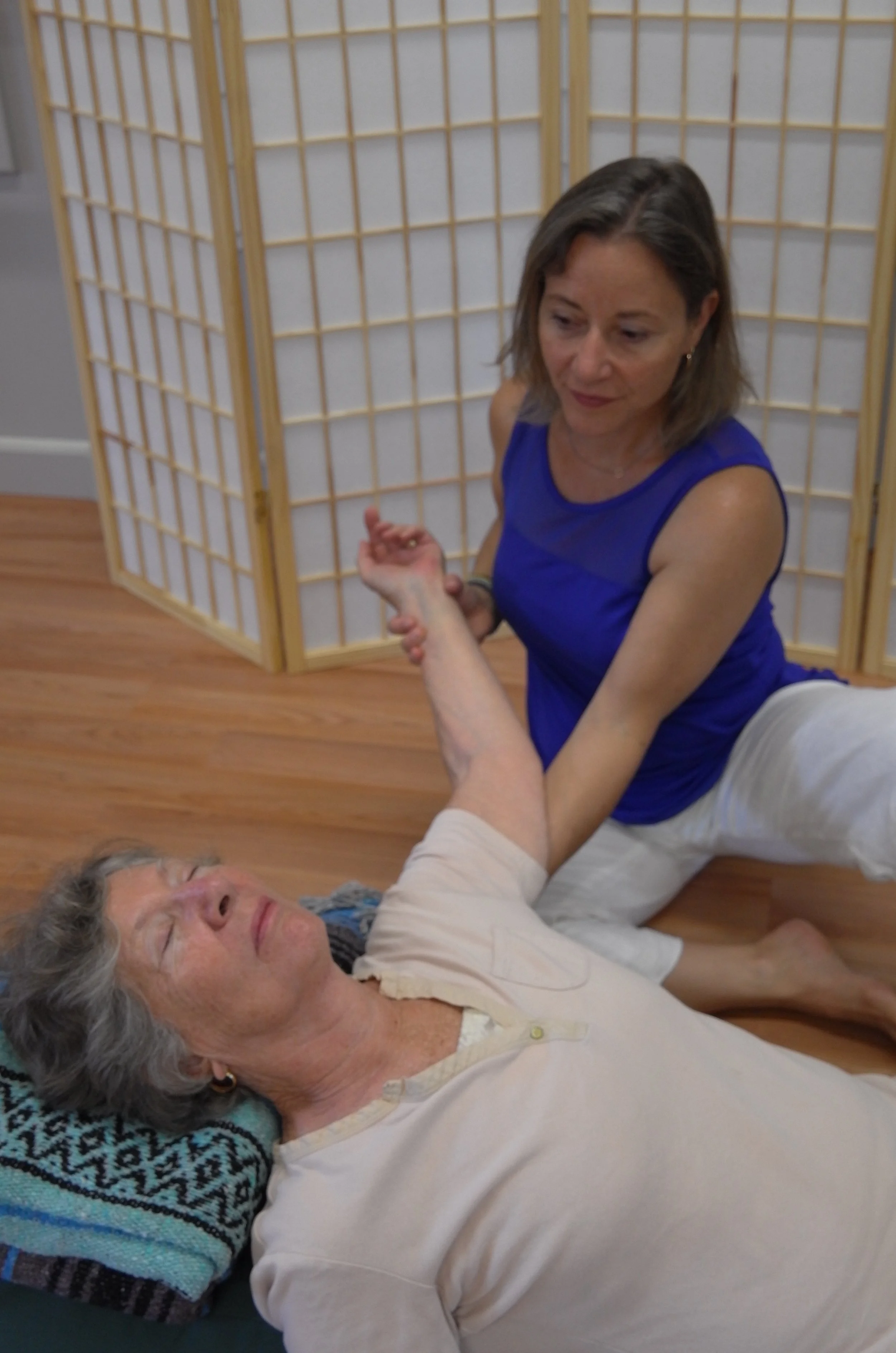 A young woman stretching, yoga in child's pose.