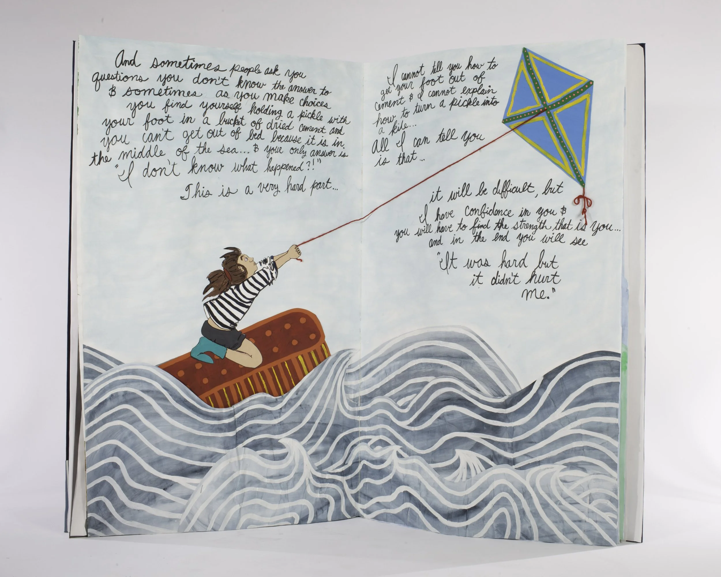 a young person with long hair holding a kite on a small rectangle in the ocean