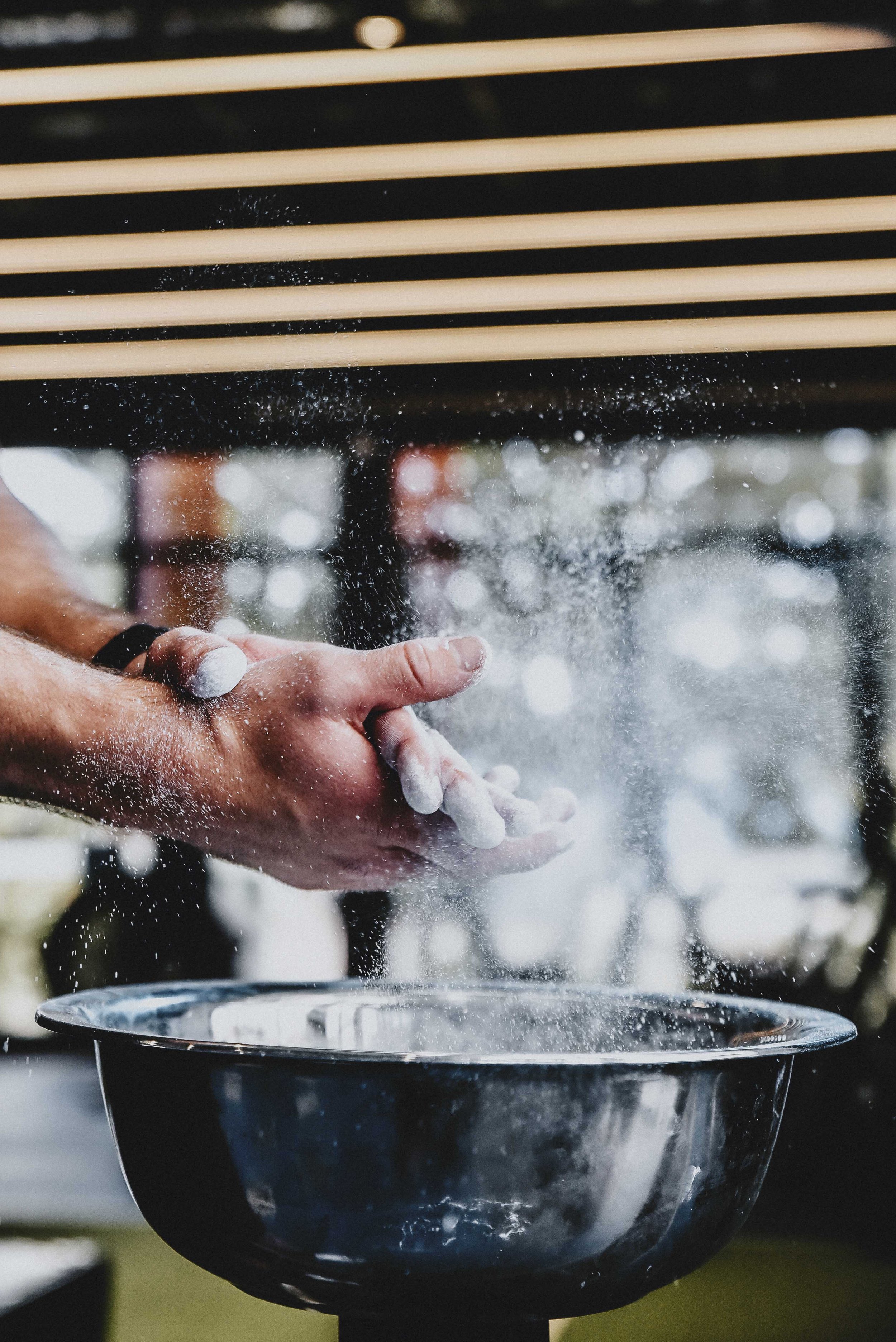 Chalking hands before a lift at O2 Performance