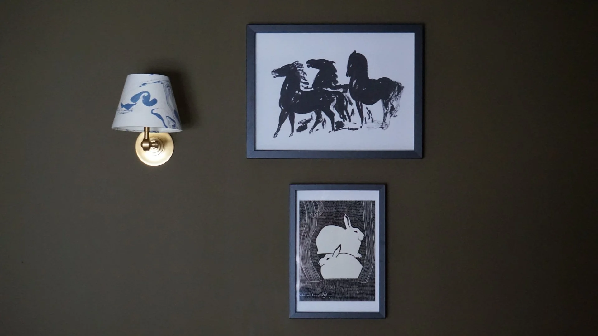 Farrow and ball dibber wall with pooky lights and artwork in black frames in bedroom