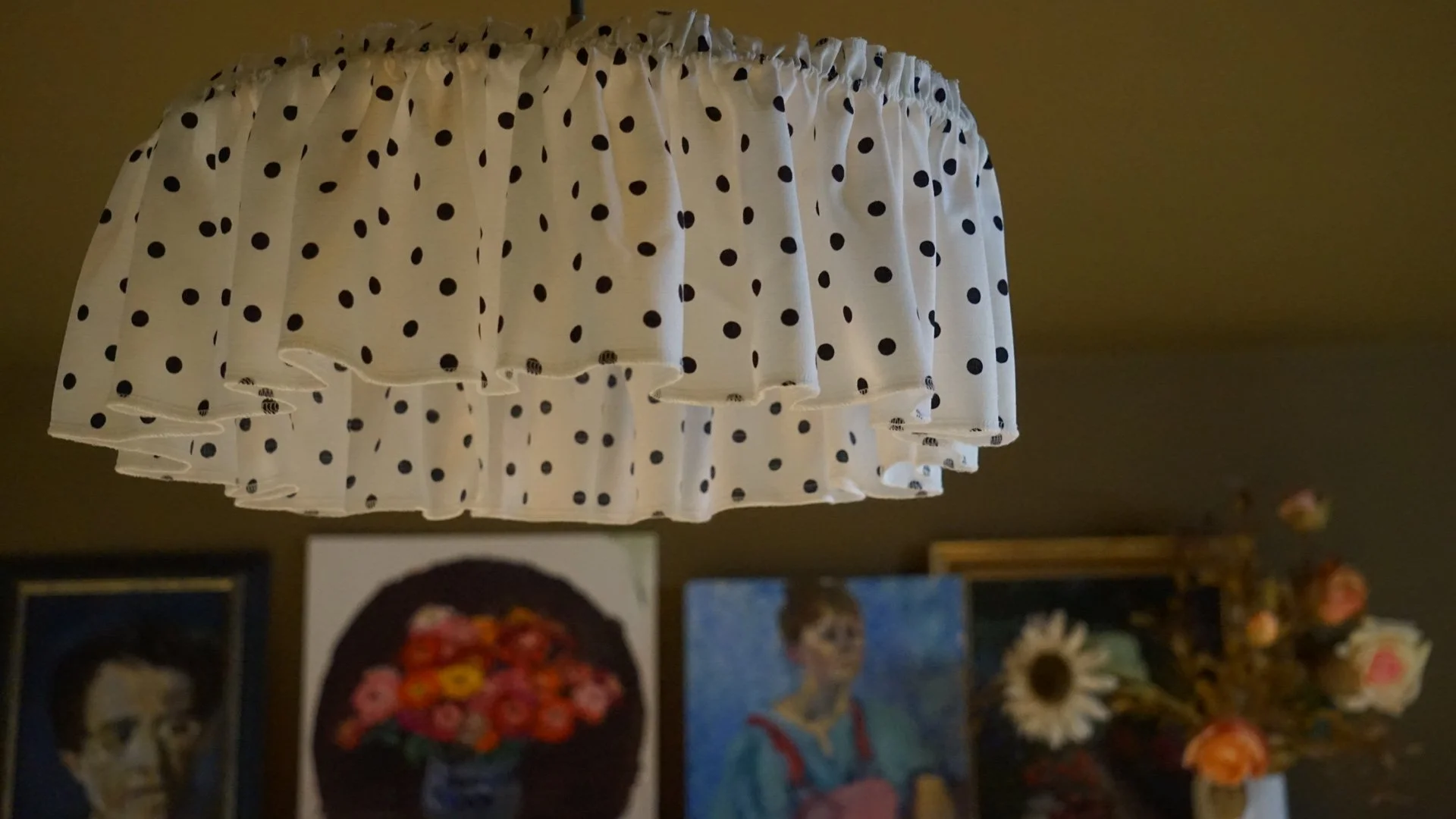 Playful polka-dot pendant light with eclectic artwork, part of a heritage interior by Stiwdio Interior Design, offering design services in Wales and Liverpool.