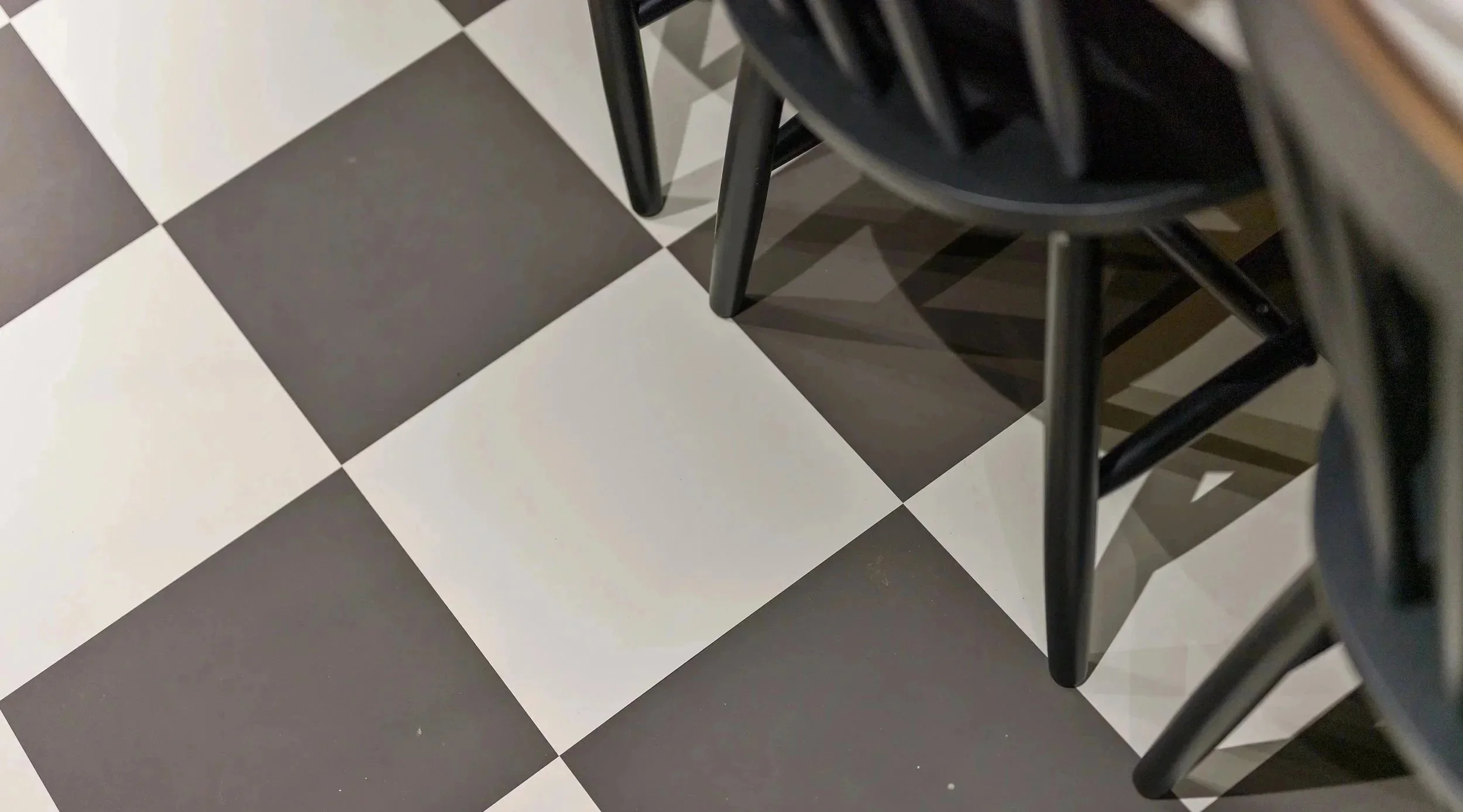 Black and white chequerboard flooring in a Liverpool heritage renovation blending Victorian character with contemporary design.