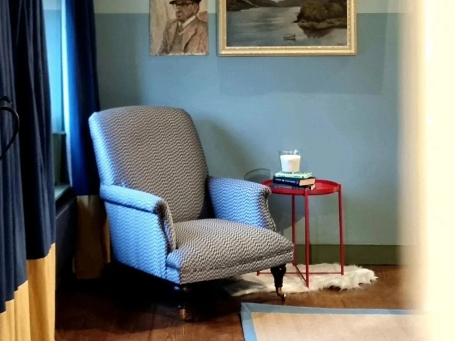 Lake District holiday cottage interior with comfortable armchair, warm tones and inviting countryside styling in Cumbria.