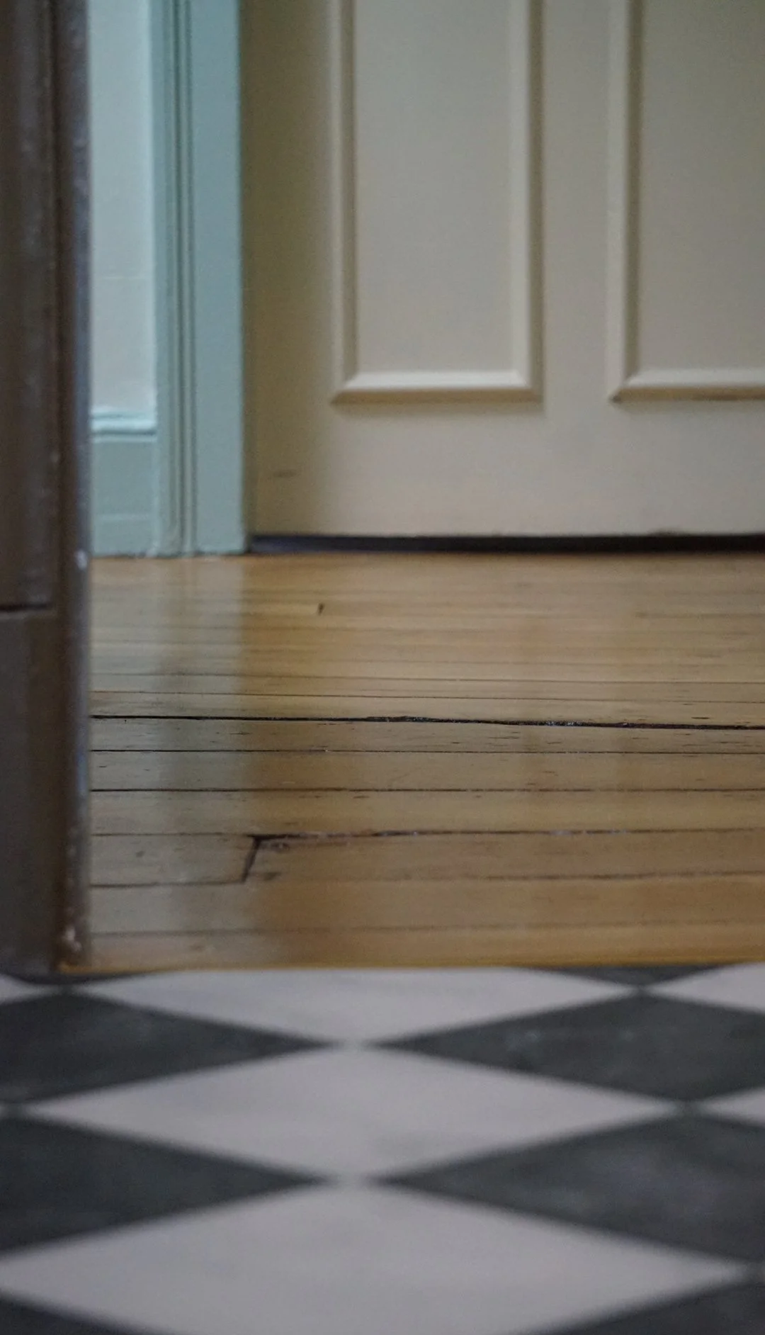 Original timber floorboards and Victorian chequerboard tiles in a Liverpool heritage renovation celebrating period craftsmanship.