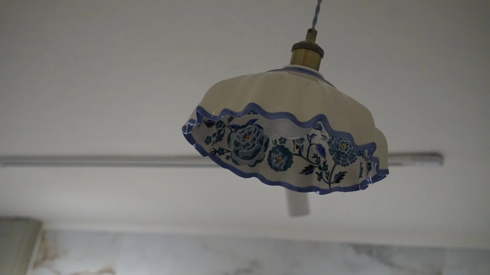 Hand-painted ceramic pendant in a Georgian Quarter Liverpool holiday let celebrating Welsh craft and heritage design.