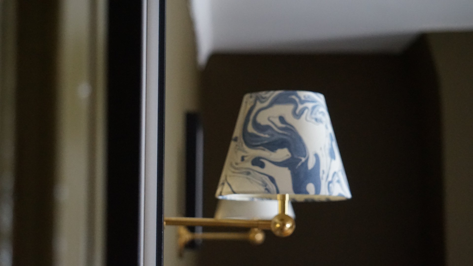 pooky wall lights in antique brass with marble shades in blue and white