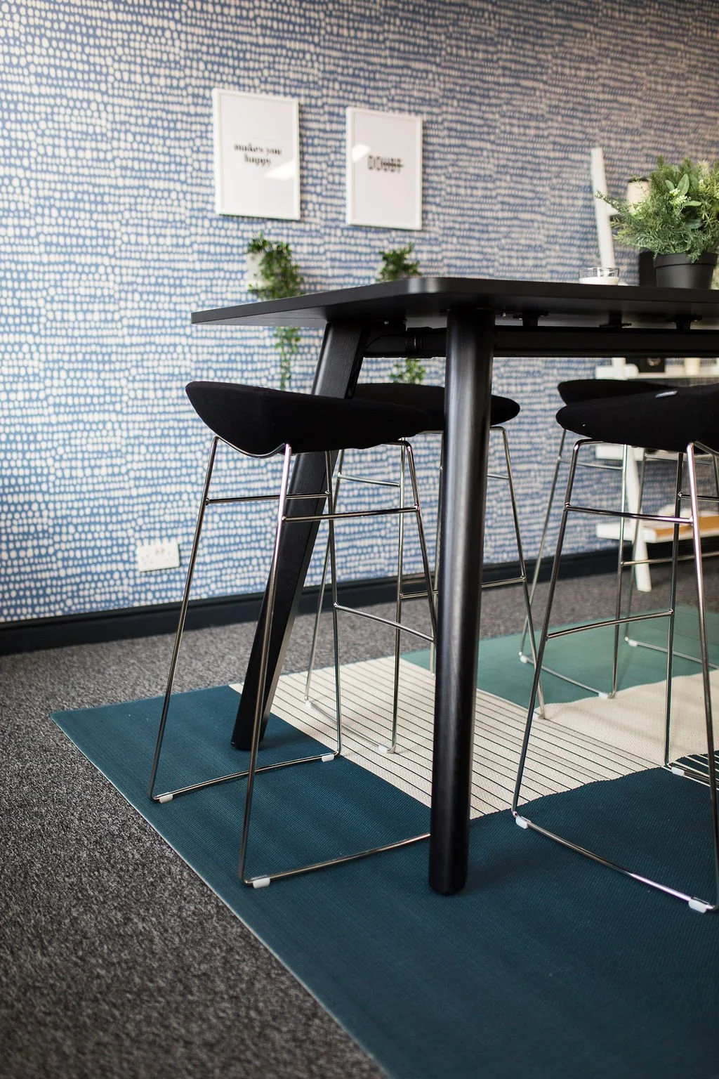 Modern breakout and collaboration area within a heritage mill office refurbishment, featuring contemporary furniture, graphic wall finishes and flexible workspace design by Stiwdio Interior Design—commercial interiors specialists serving North Wales 