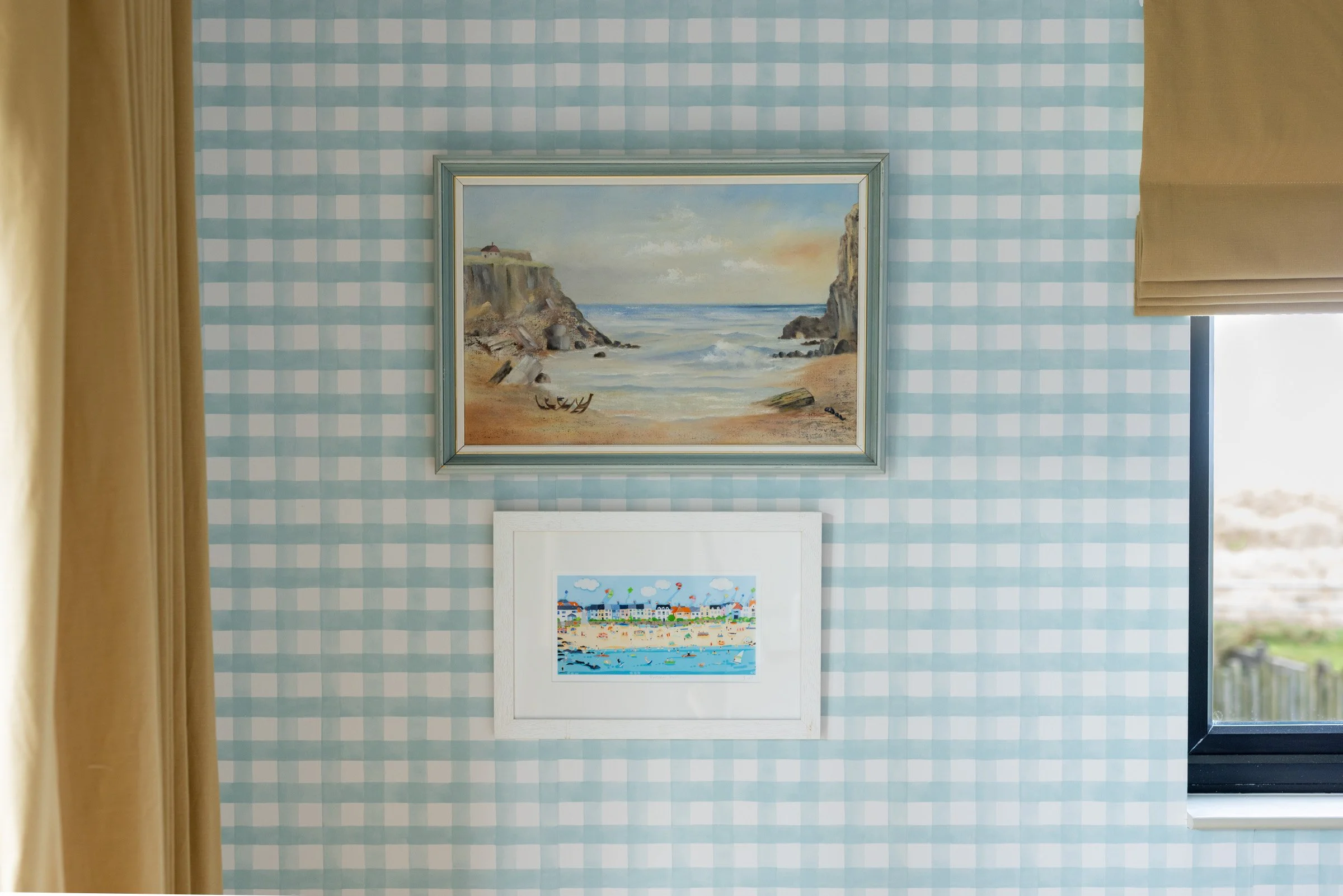 Soft blue gingham and coastal artwork capture the carefree spirit of beach hut living in this Anglesey seaside retreat.