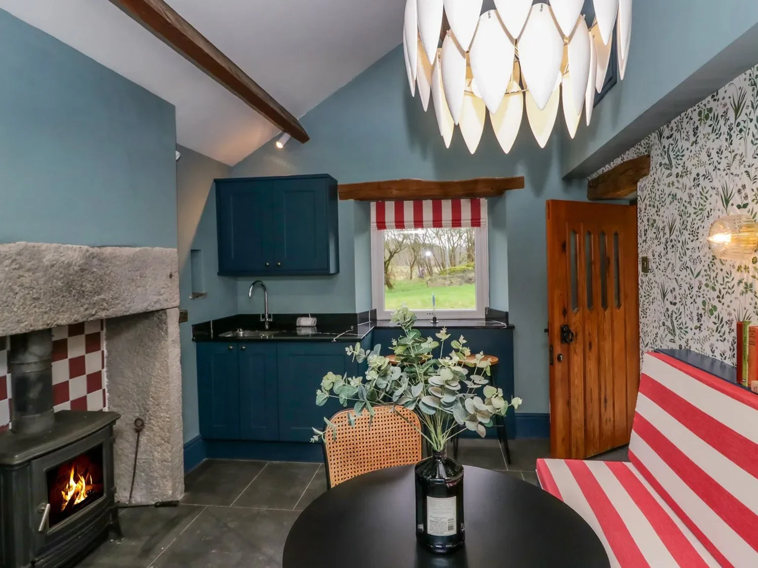 Lake District cottage renovation in Cumbria featuring country kitchen, wood burner and exposed beams with contemporary styling.