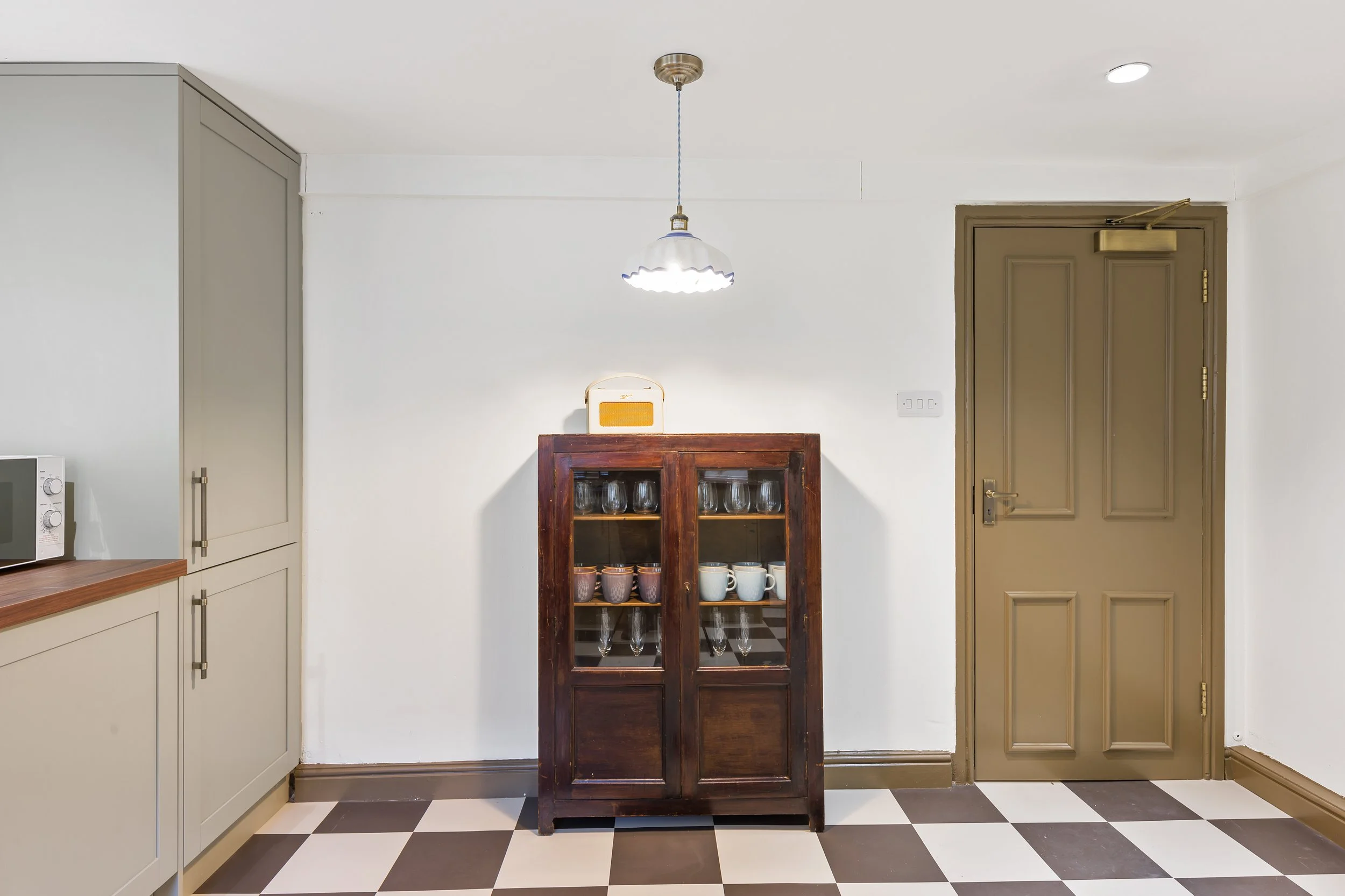 Georgian Quarter Liverpool holiday let blending heritage cabinetry, checkerboard flooring and Welsh-inspired craftsmanship for a boutique city stay.