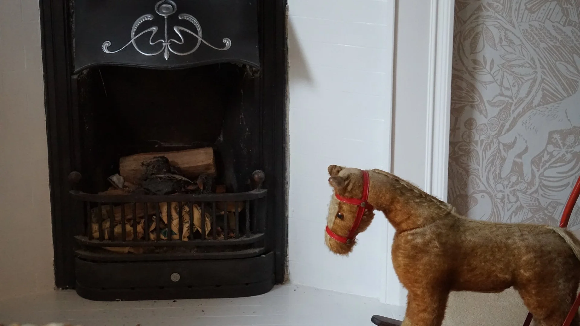 Anglesey country house refurbishment featuring restored cast iron fireplace, heritage detailing and warm country interior styling in North Wales.