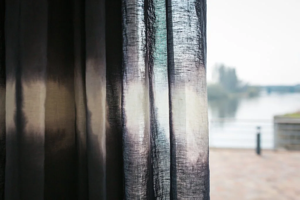 Navy sheer curtain draped on window of showhome