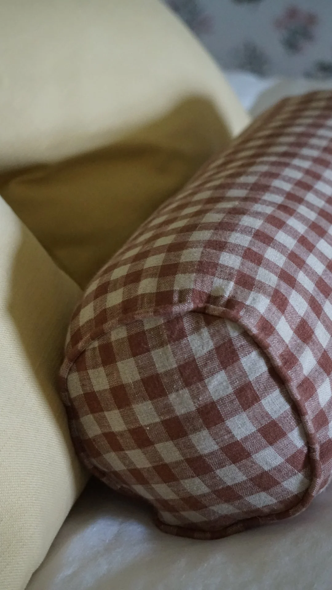 Anglesey country house refurbishment featuring bespoke gingham bolster cushion by poppy & honesty and layered country textiles by Stiwdio Interior Design, North Wales.