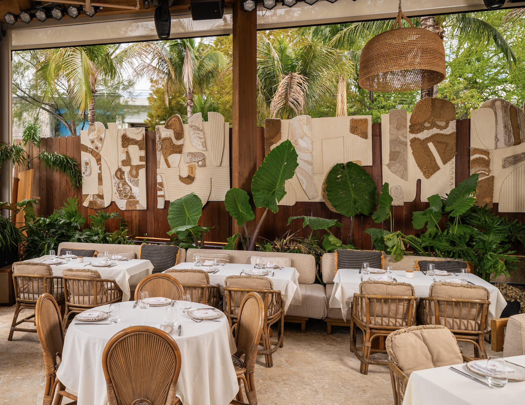 Tables and chairs in the beach club area of CASA NEOS.
