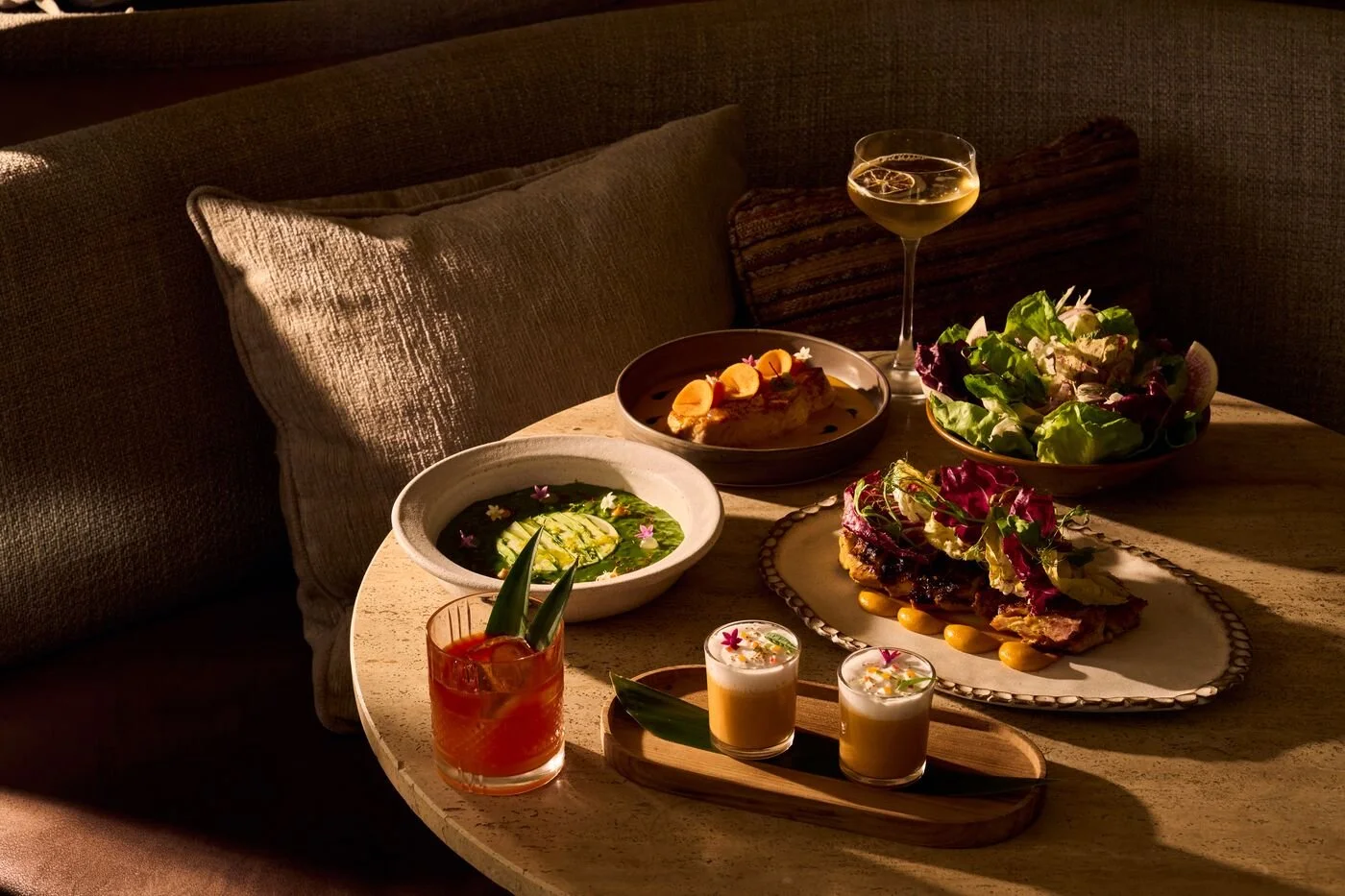 Image of CASA NEOS Summer menu items on a table, including 2 cocktails, and five dishes.
