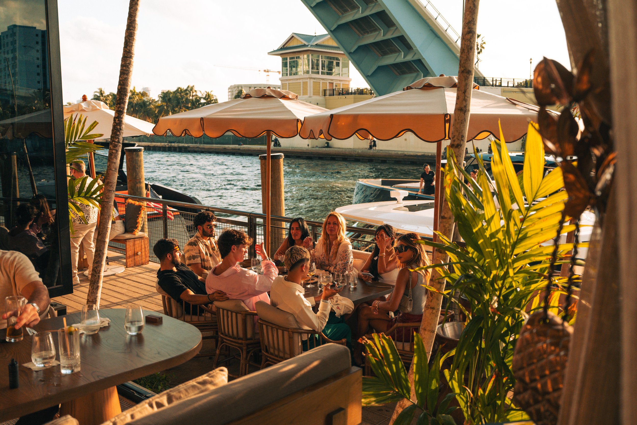 Image of a family dining at the beach club during sunset hours.