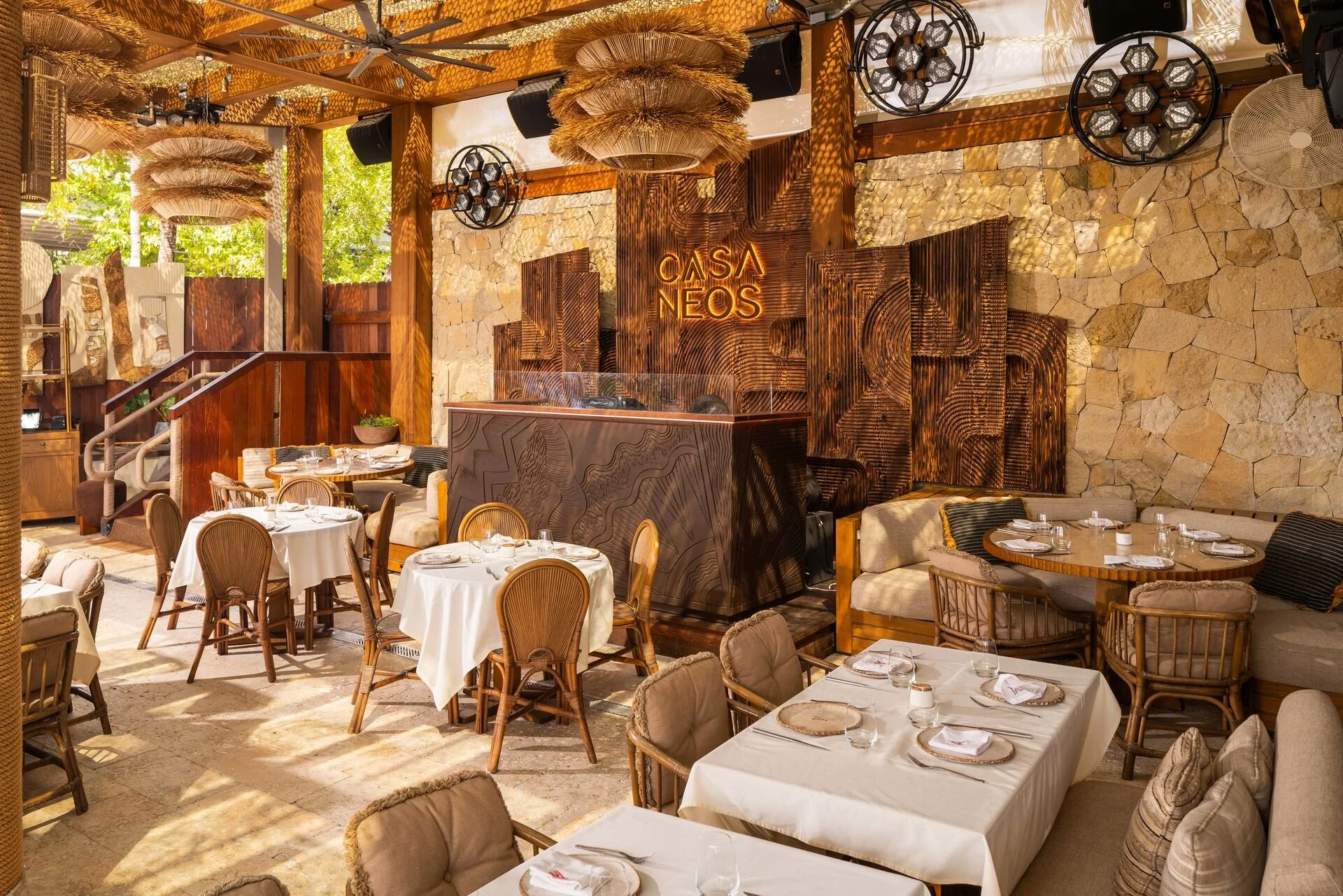 Private event space in CASA NEOS Beach Club dining setting, with the DJ booth in the back.