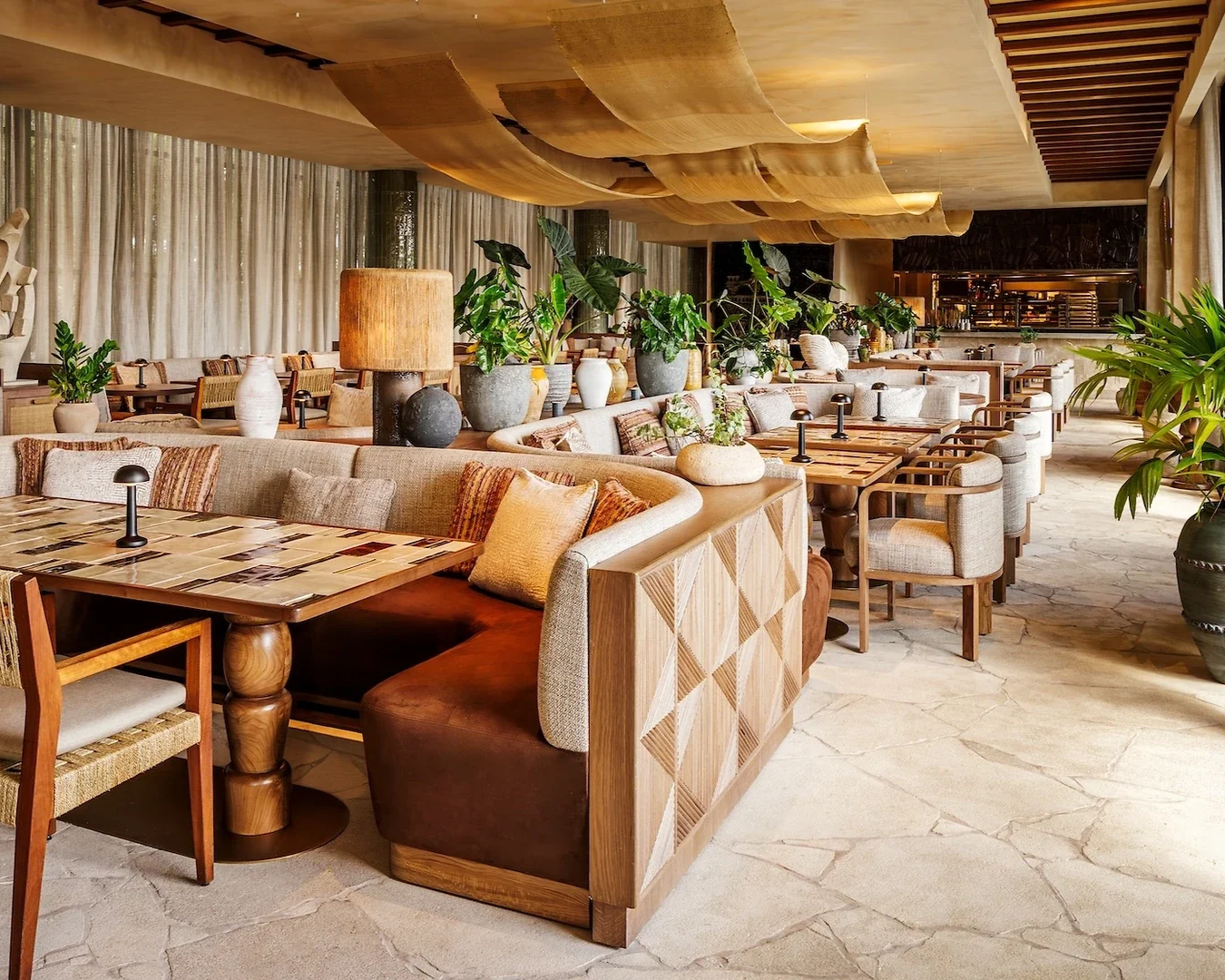 Image of CASA NEOS first floor dining space, with plants around the tables.
