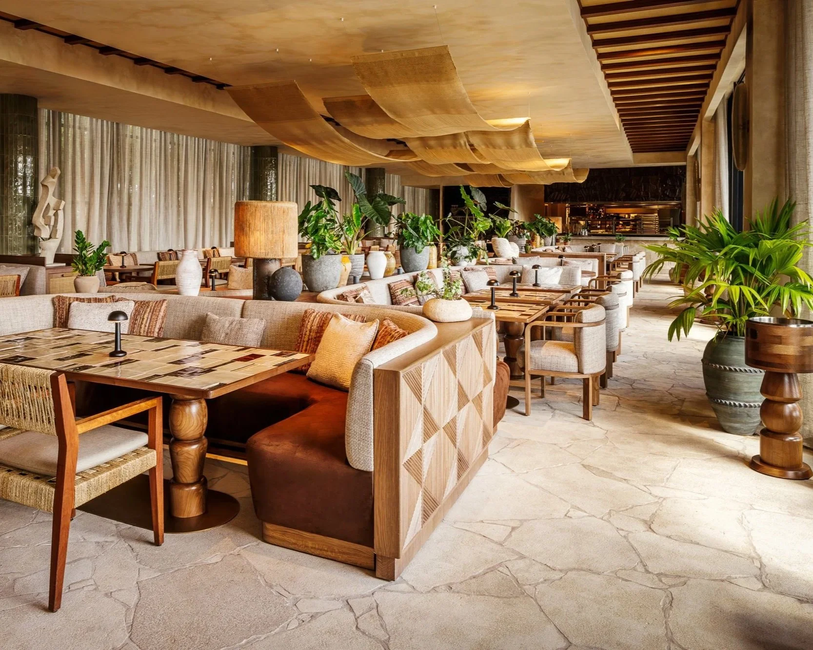 Outdoor dining of CASA NEOS, with tables, chairs and plants.