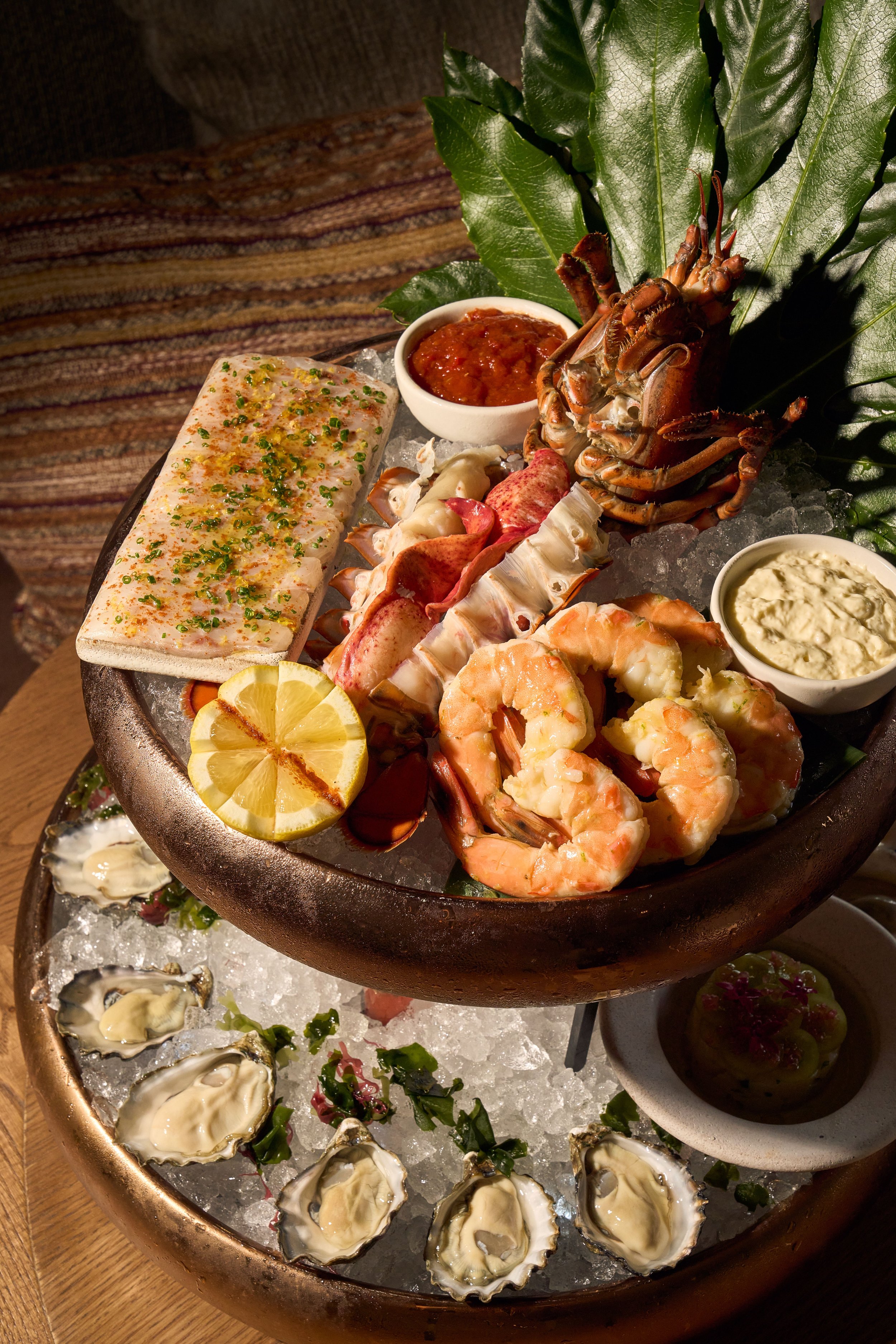 A very impressive display of the seafood tower composed of oysters on the bototm tier, and lobster, shrimp with sauces on the top tier.