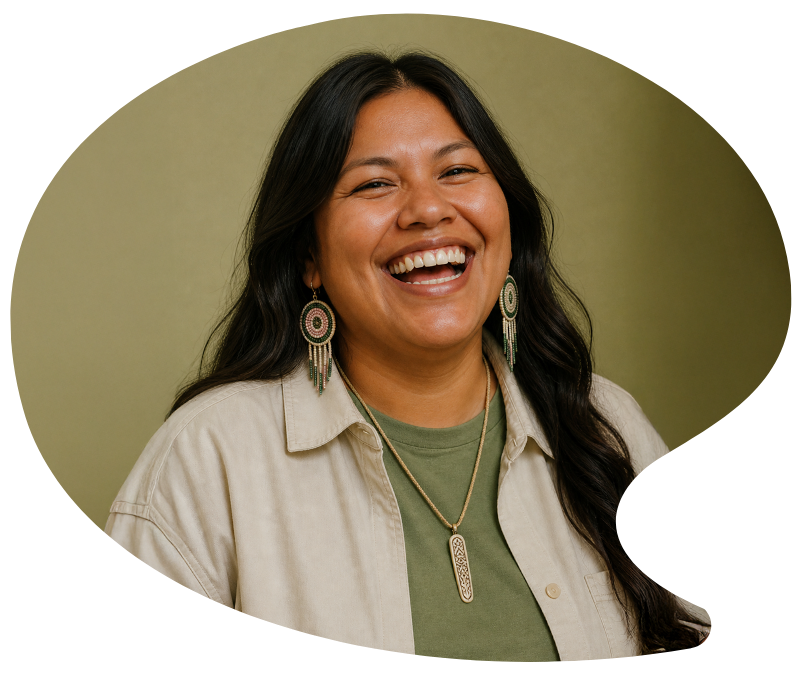Woman with long dark hair laughing, wearing a beige jacket, green shirt, and statement jewelry, against a green background.