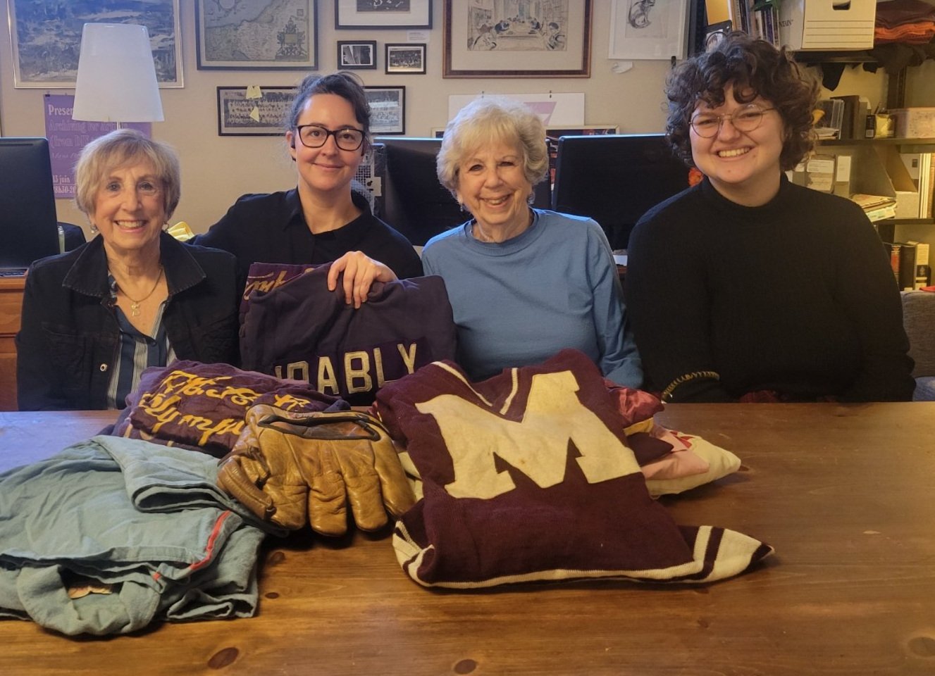 Leona Sternfeld and Sandra Shadowitz donating the sports uniforms worn by their mother, Ida Bly, to her archival collection. Accompanied by Maya Pasternak and Sam Pappas of the JPL Archives. November 7, 2024