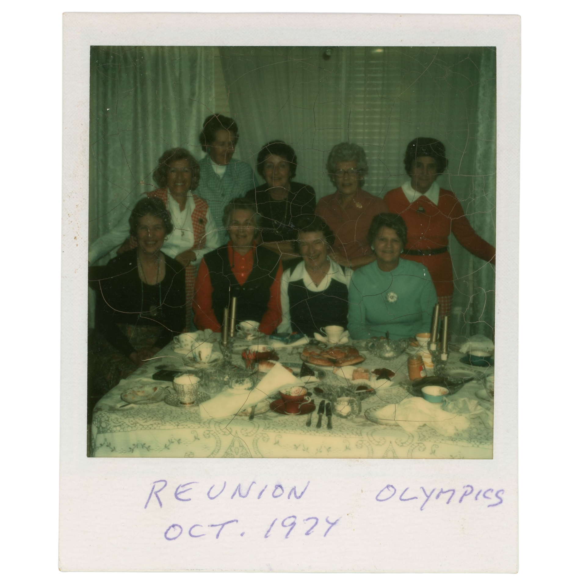 Polaroid photograph of members of the Olympics basketball team around a table taken at a team reunion in October 1974. Ida Bly is second from left in the back row. JPL Archives, Ida Bly Fonds, 1482-1-[2]-079