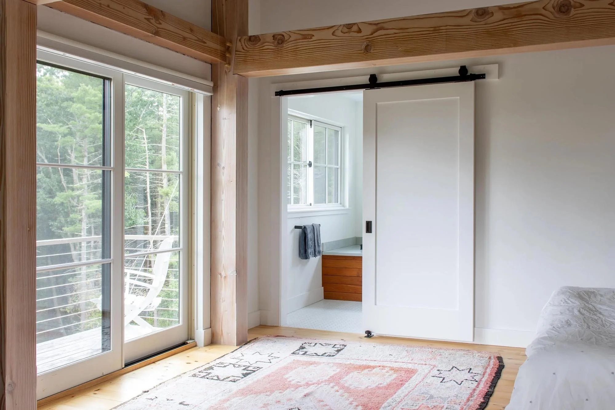 primary bedroom and bath suite with private deck and horizontal cable rail