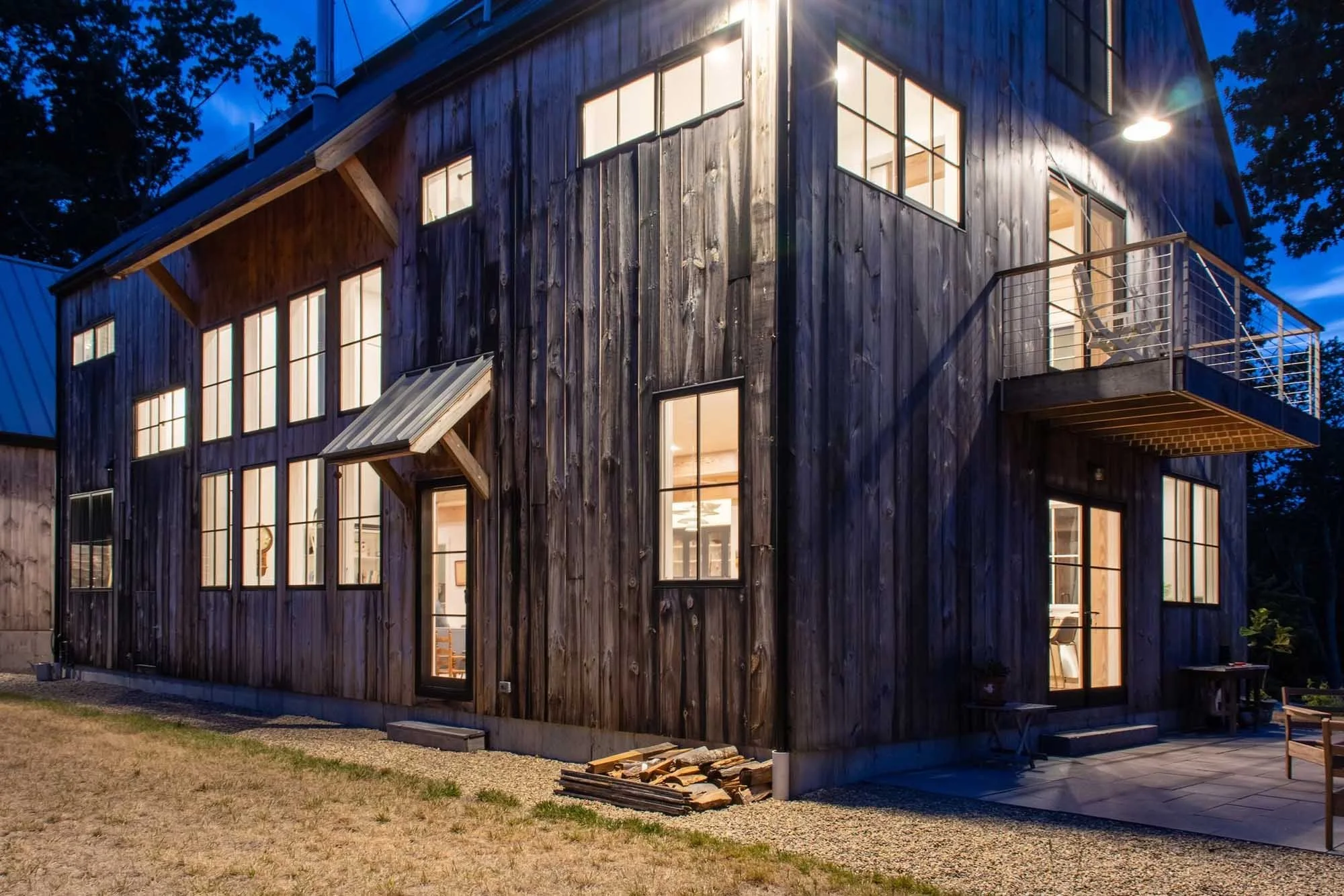 exterior of custom home with vertical wood siding and black modern windows
