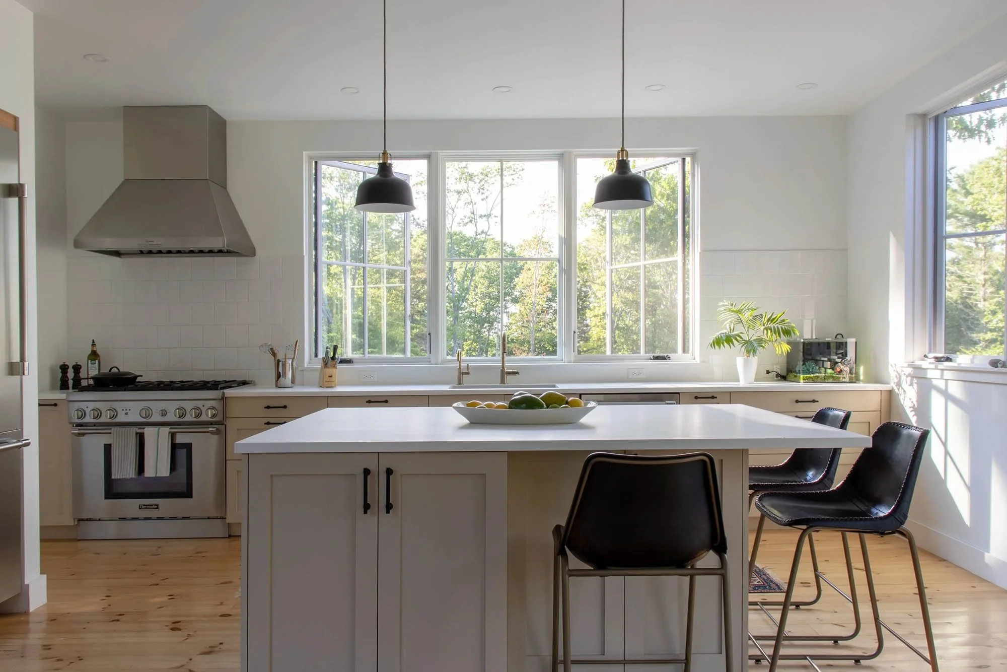 custom kitchen with lots of windows and beige cabinets
