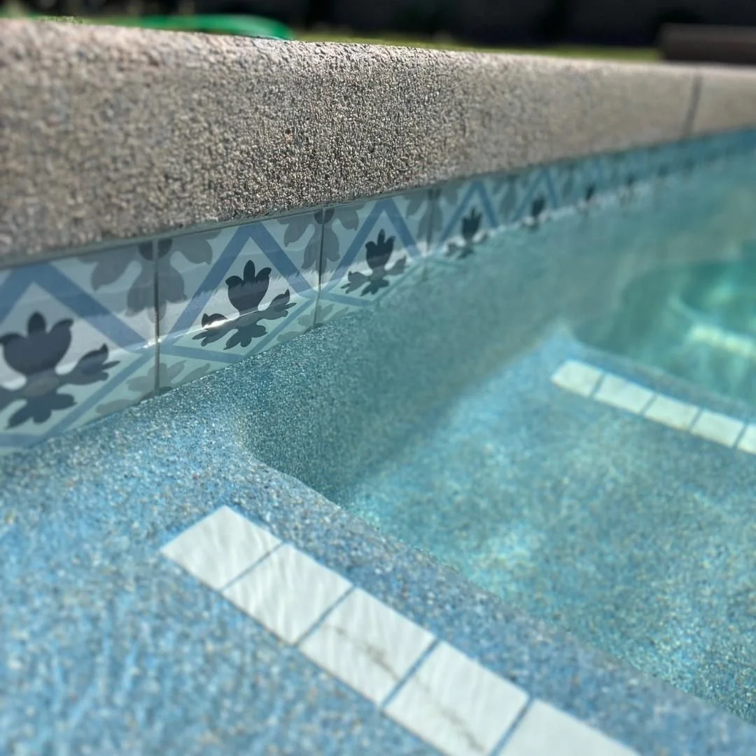 Waterline tiles from QDI and Laguna White mini pebble from Universal White Cement