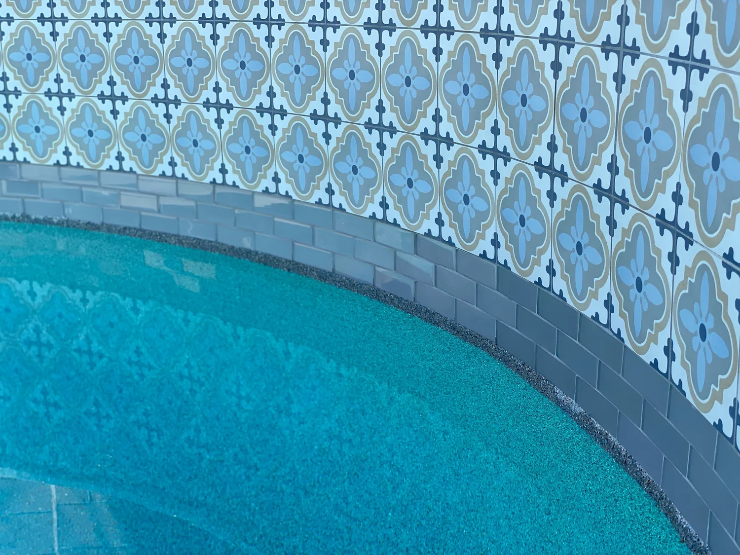 Decorative blue patterned waterline tile installed by Mercury Pools