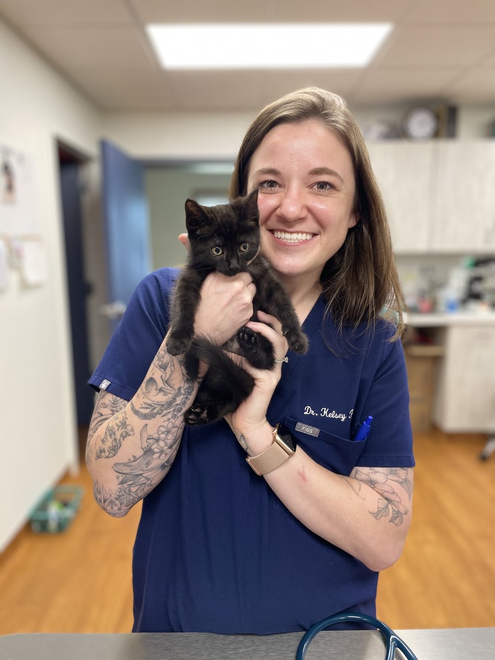 Dr. Parker holding a black kitten