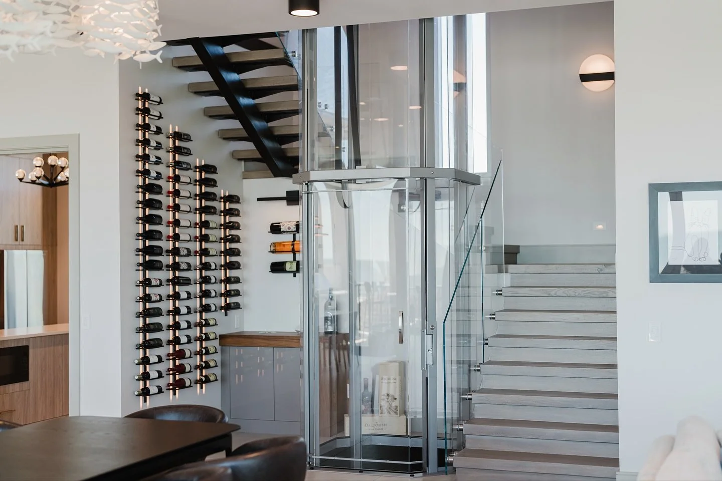 An elevator down to the laundry room for weekend chores?? Yes, please! 🧺 
.
.
.
#home #homebuilder #homesweethome #interiordesign #laundry #laundryroom #laundryday #elevatordesign #glasselevator #customhome #customhomes #customhomebuilder #hiltonhea