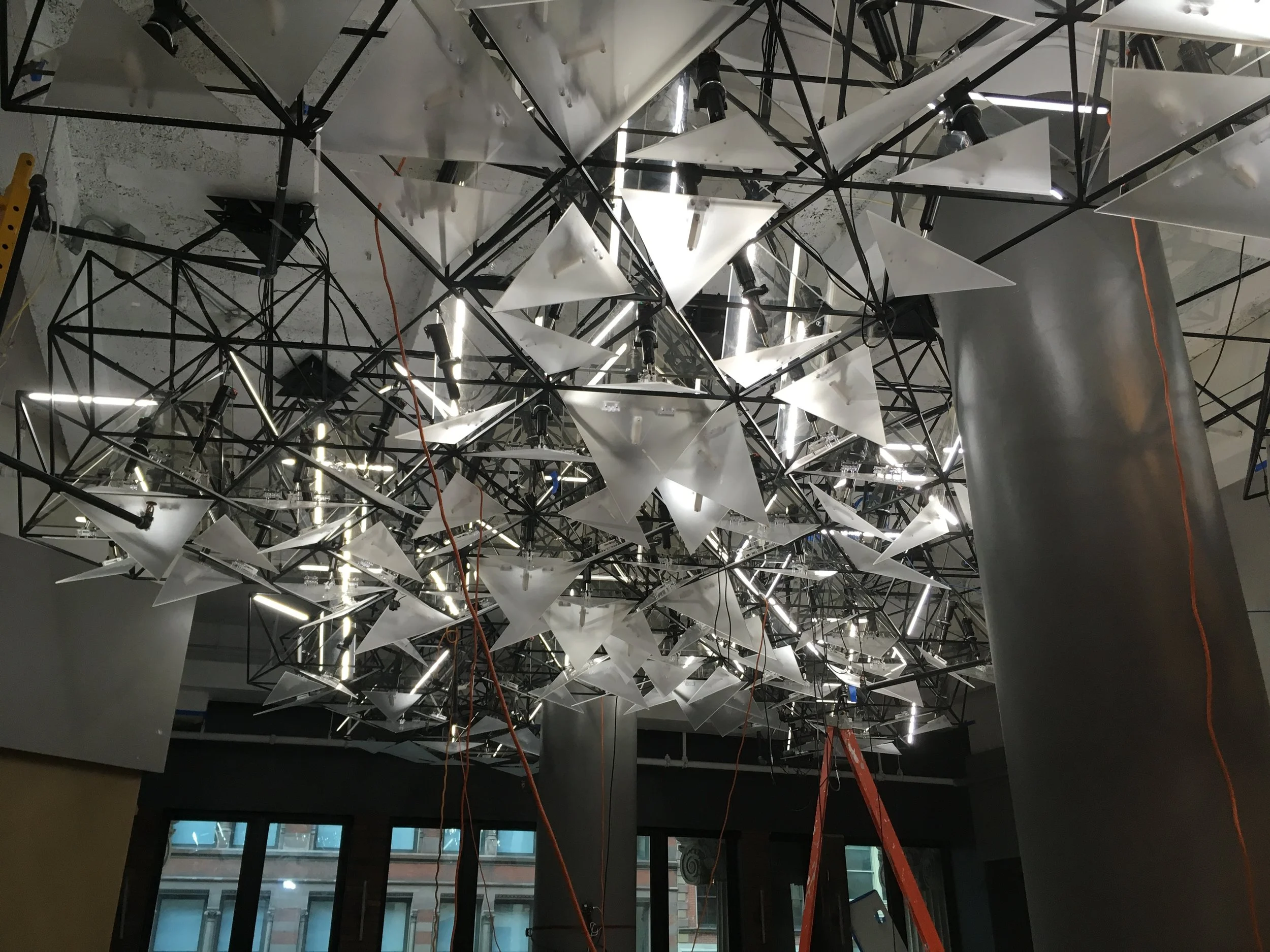 The ceiling mounted sculpture with kinetic panels.