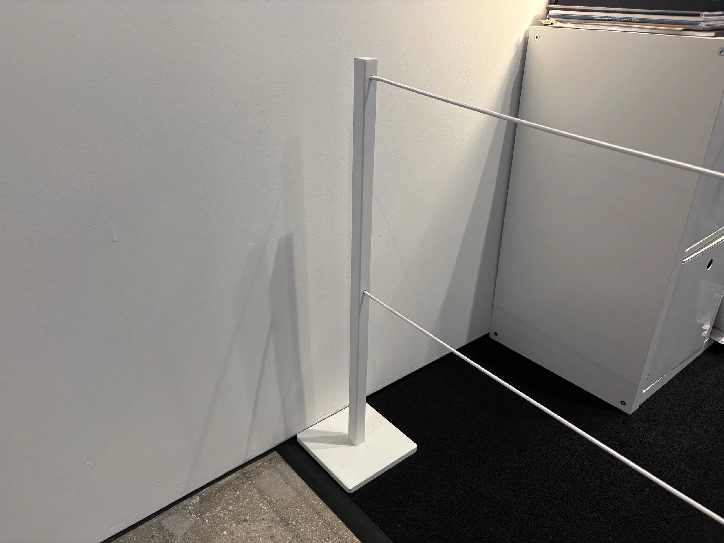 Stanchion for gallery space. TIG welded steel, enamel finish.