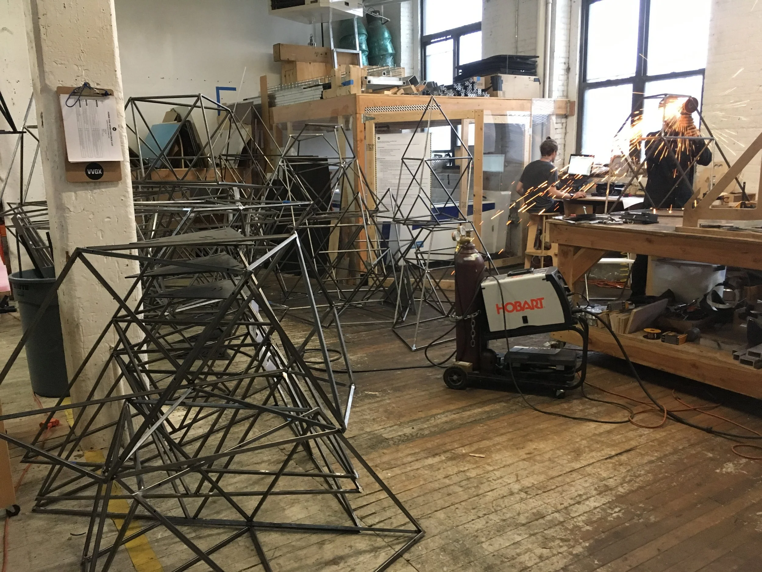 Fabricating the steel bases for a ceiling mounted kinetic sculpture.