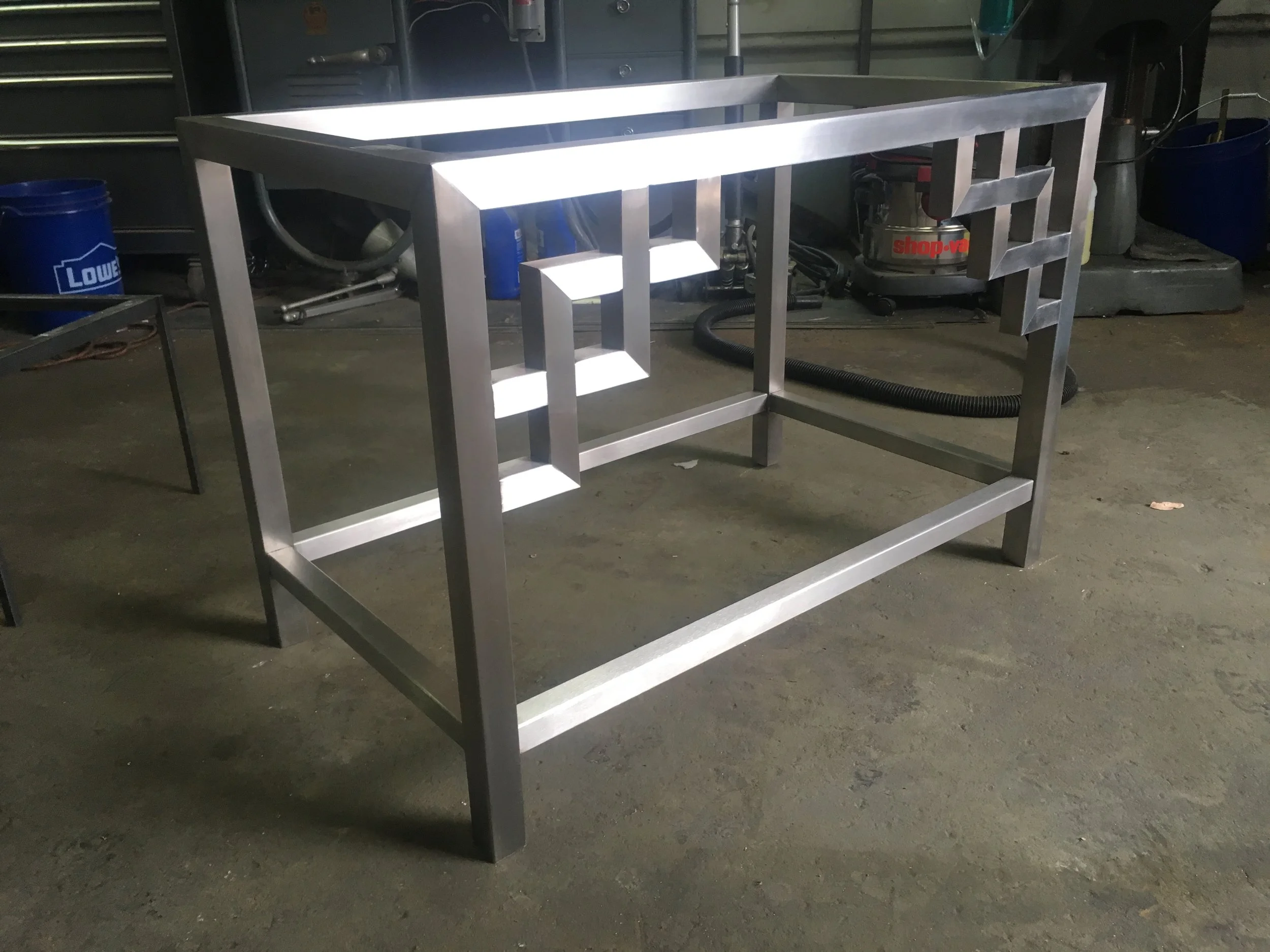Custom stainless steel table with brushed finish.