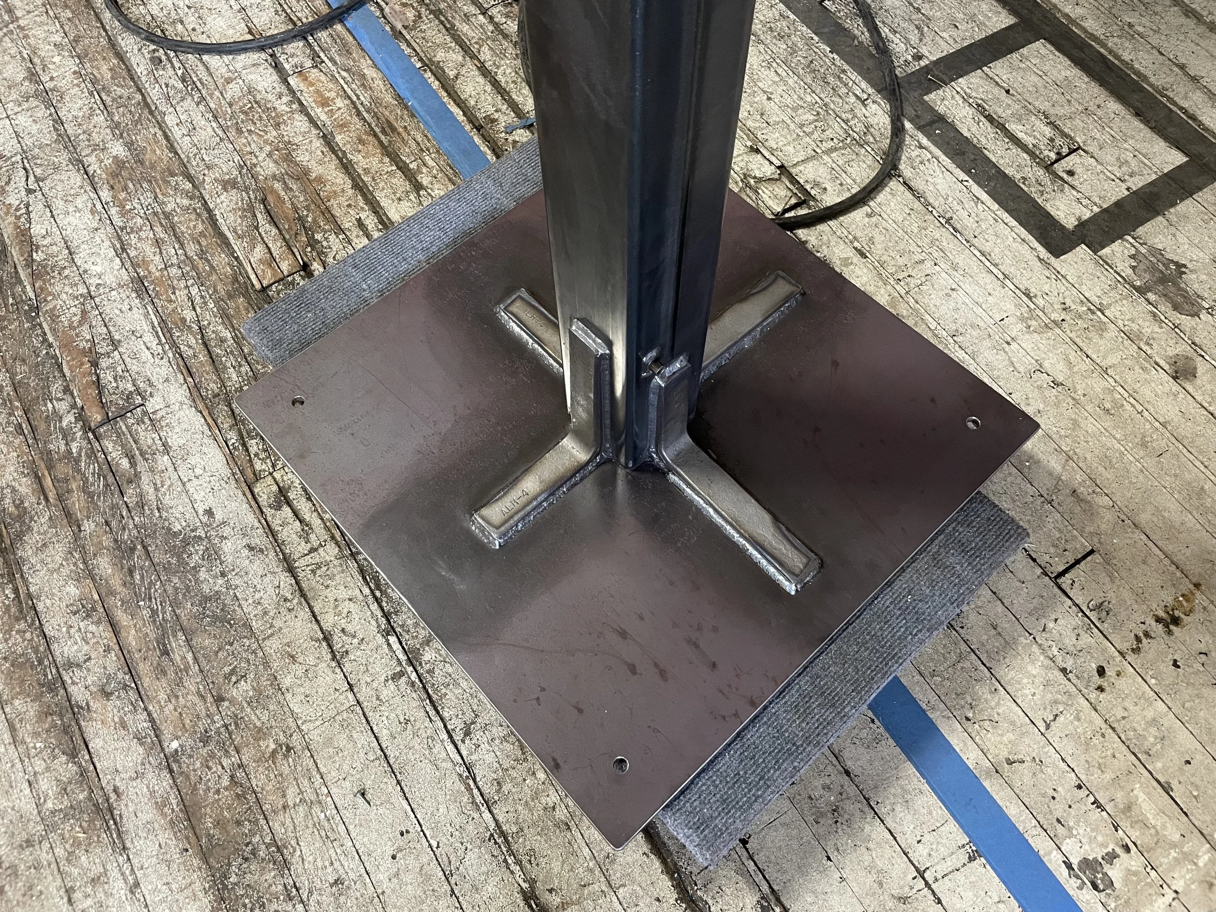 tubing and brackets welded to 1/2" plate steel for a support beam.