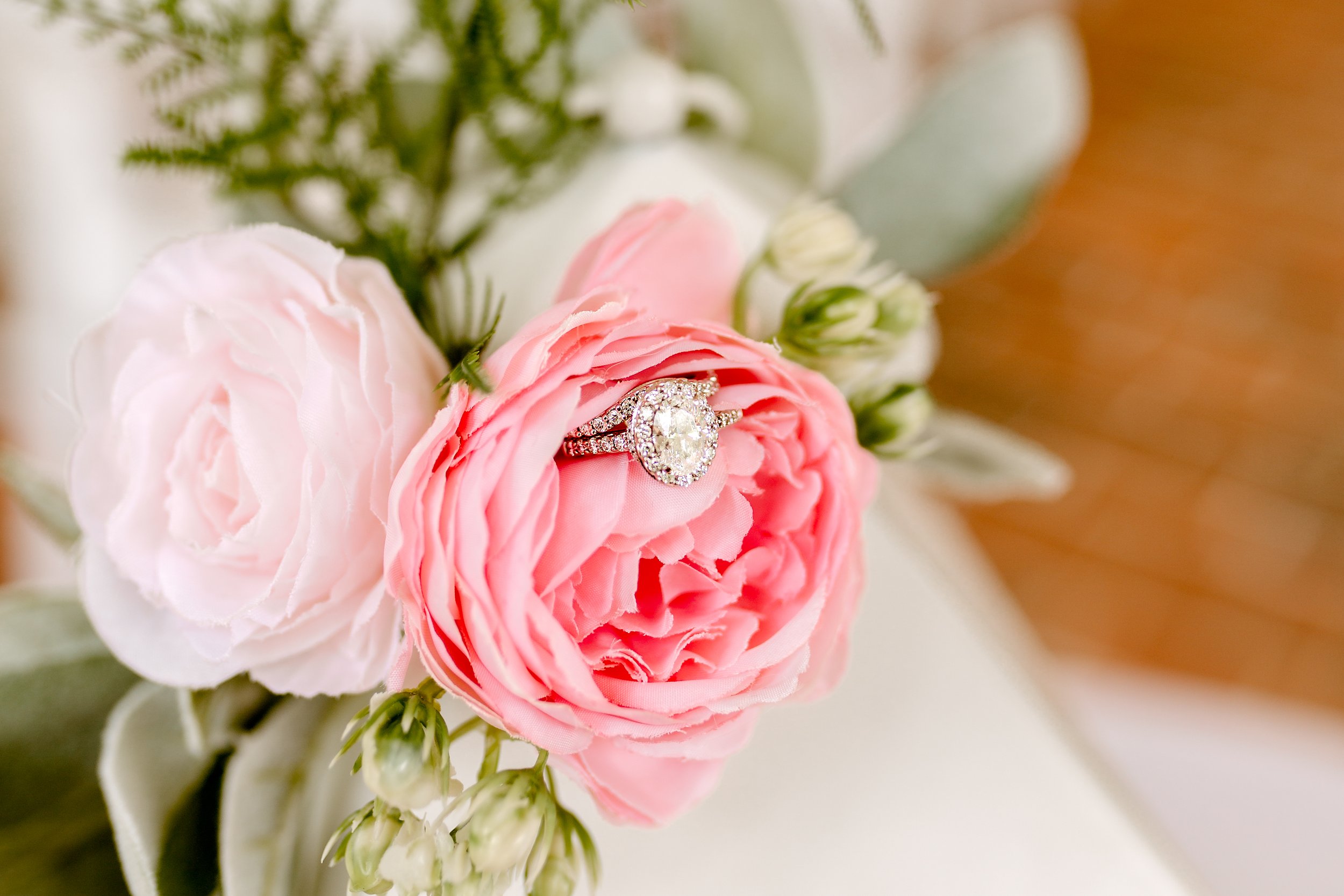 brides wedding ring and engagement ring photographed with a bouquet of flowers in Kentucky