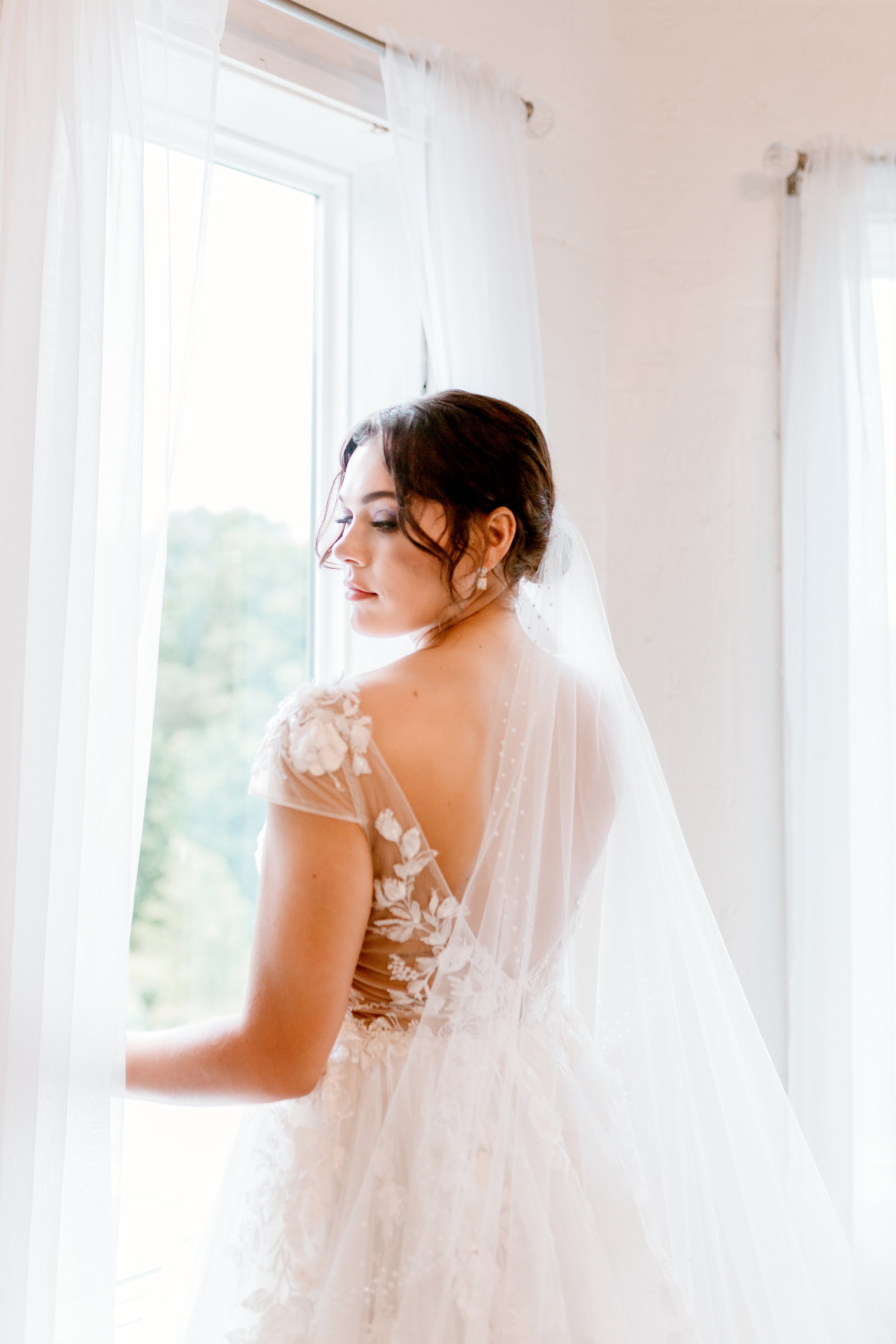 bride at window wearing her dress in kentucky