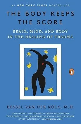 Book cover for 'The Body Keeps the Score' by Bessel van der Kolk, featuring a black silhouette of a person with a red heart on the chest, surrounded by yellow star-like shapes on a blue background.