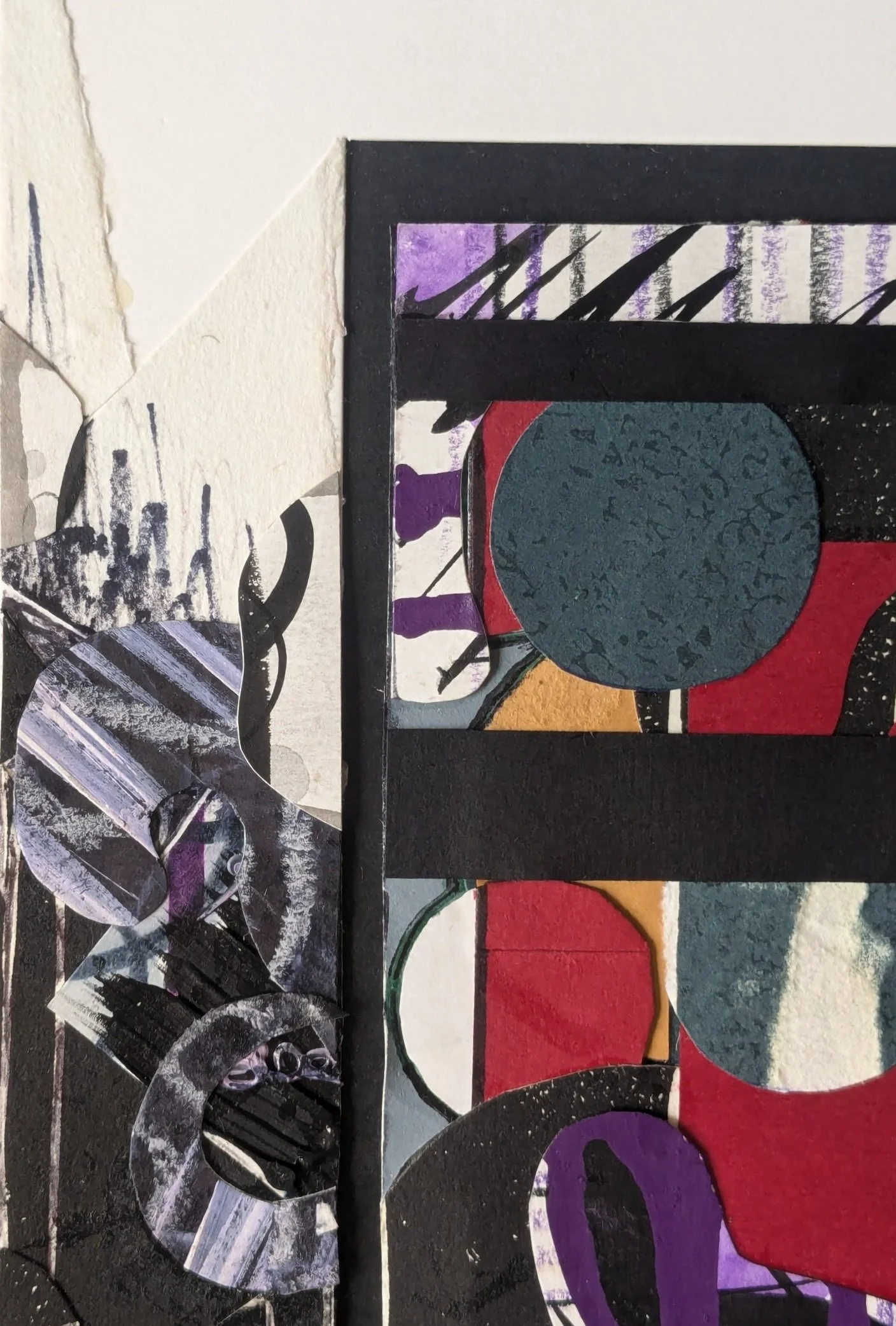 Close-up of a colorful abstract mixed media art piece featuring circles, rectangles, and textured patterns in various colors including purple, red, blue, black, and white.